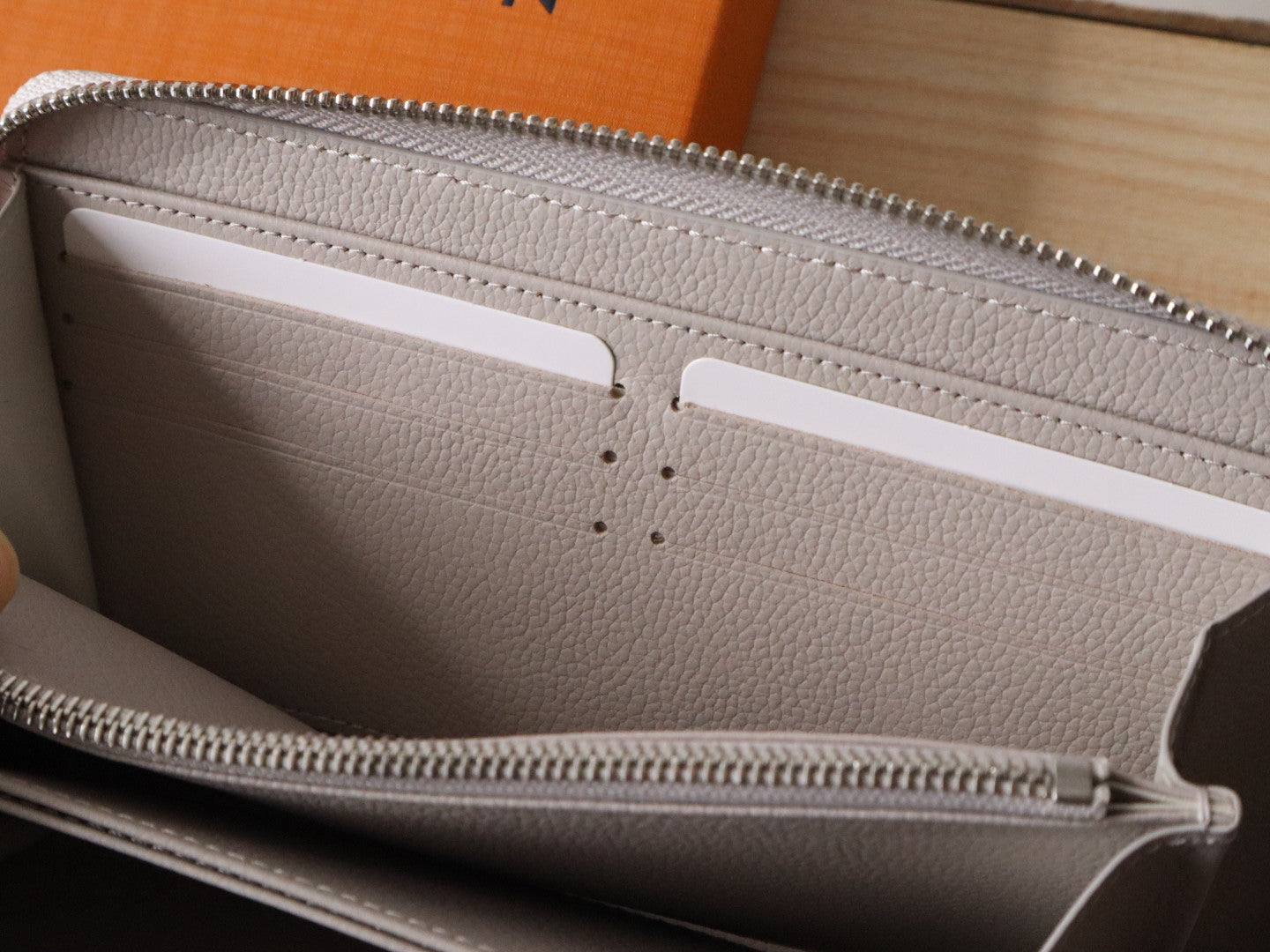 Elegant Louis Vuitton Light Gray Embossed Leather Zip Around Wallet for Luxury Enthusiasts M14228