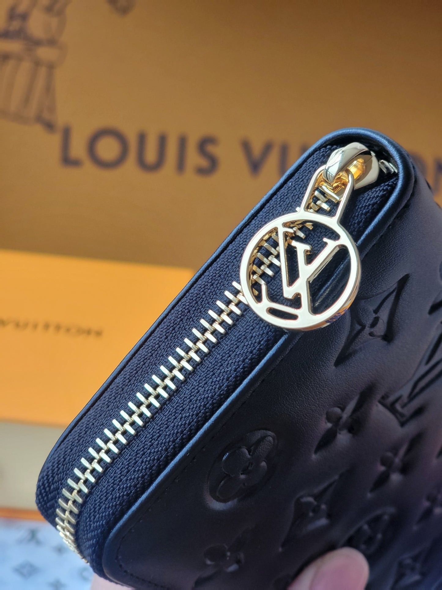 Elegant Louis Vuitton Black Embossed Leather Zip Around Wallet With Gold Accents