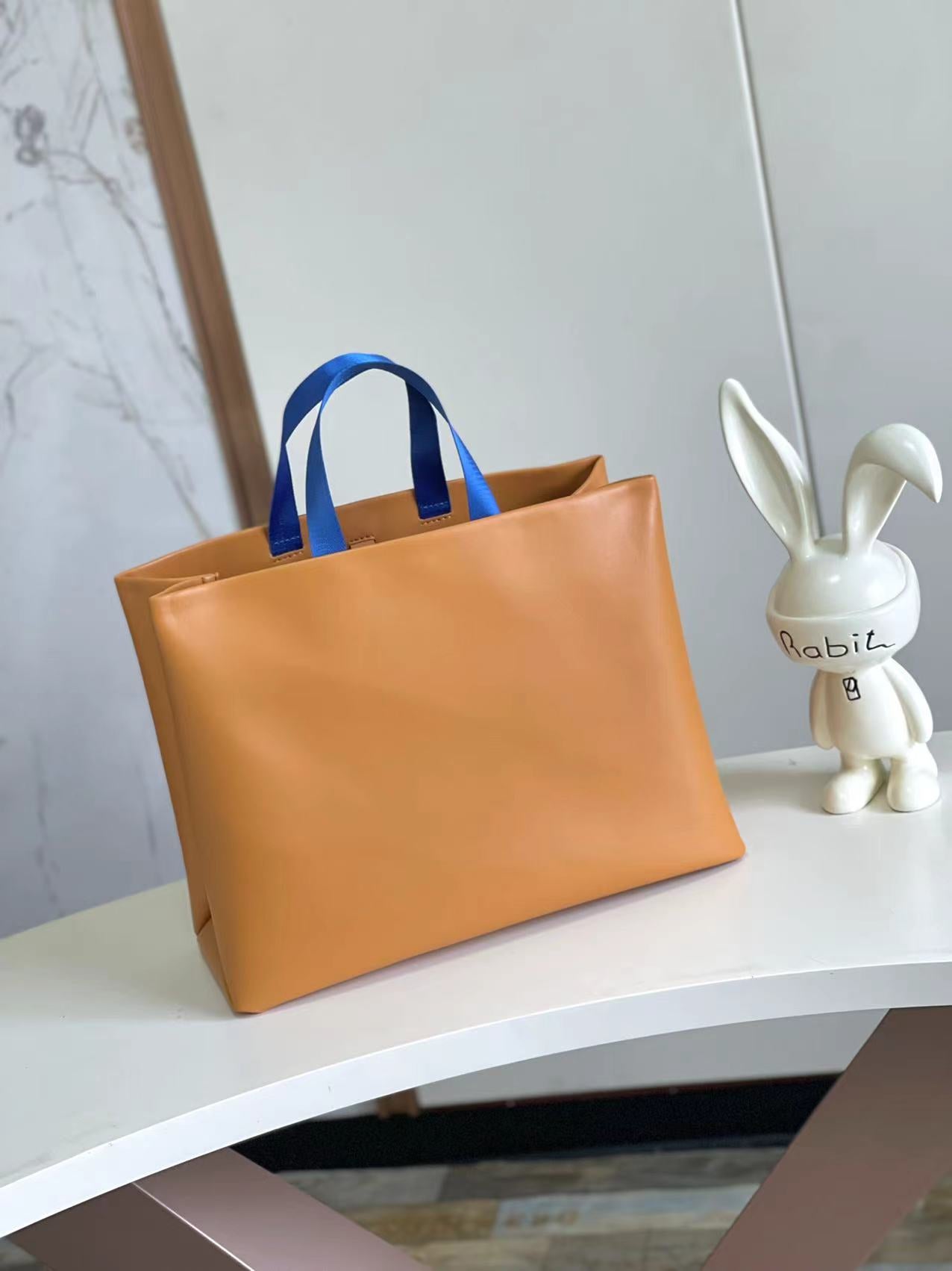 Stylish Orange Louis Vuitton Tote Bag With Blue Handles And Branding