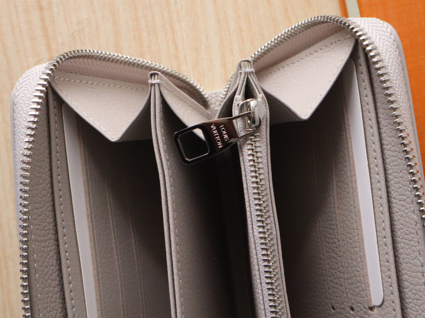 Elegant Louis Vuitton Light Gray Embossed Leather Zip Around Wallet for Luxury Enthusiasts M14228
