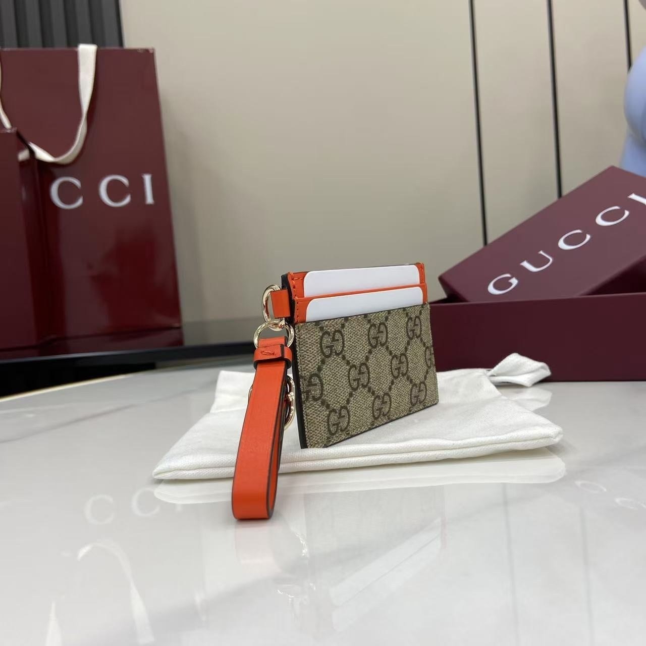 Chic Gucci Card Holder With Signature GG Pattern Orange Accents And Wrist Strap 819121