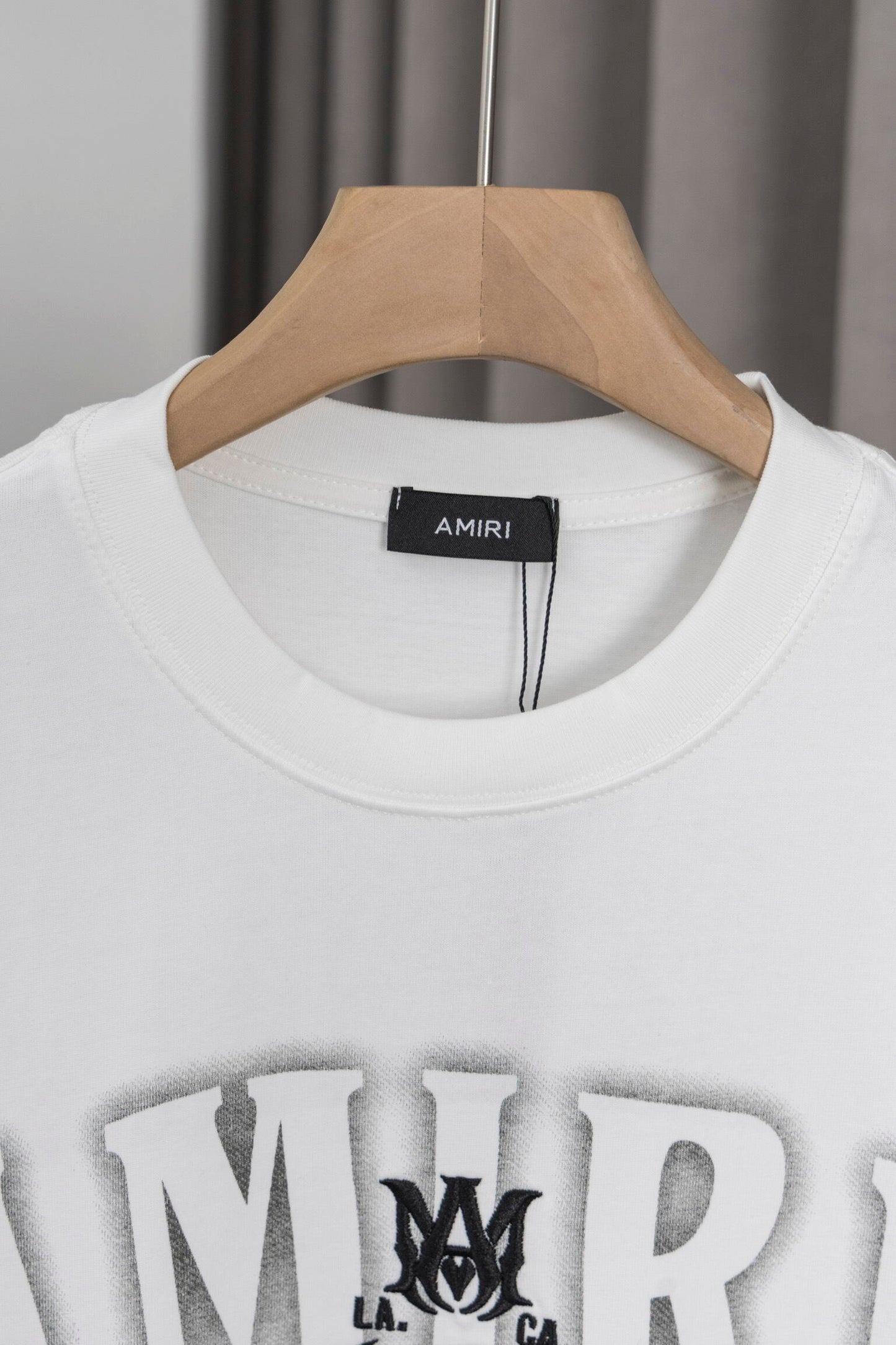 AMIRI White/Black Graphic Tee With Bold Logo For Trendy Streetwear Enthusiasts