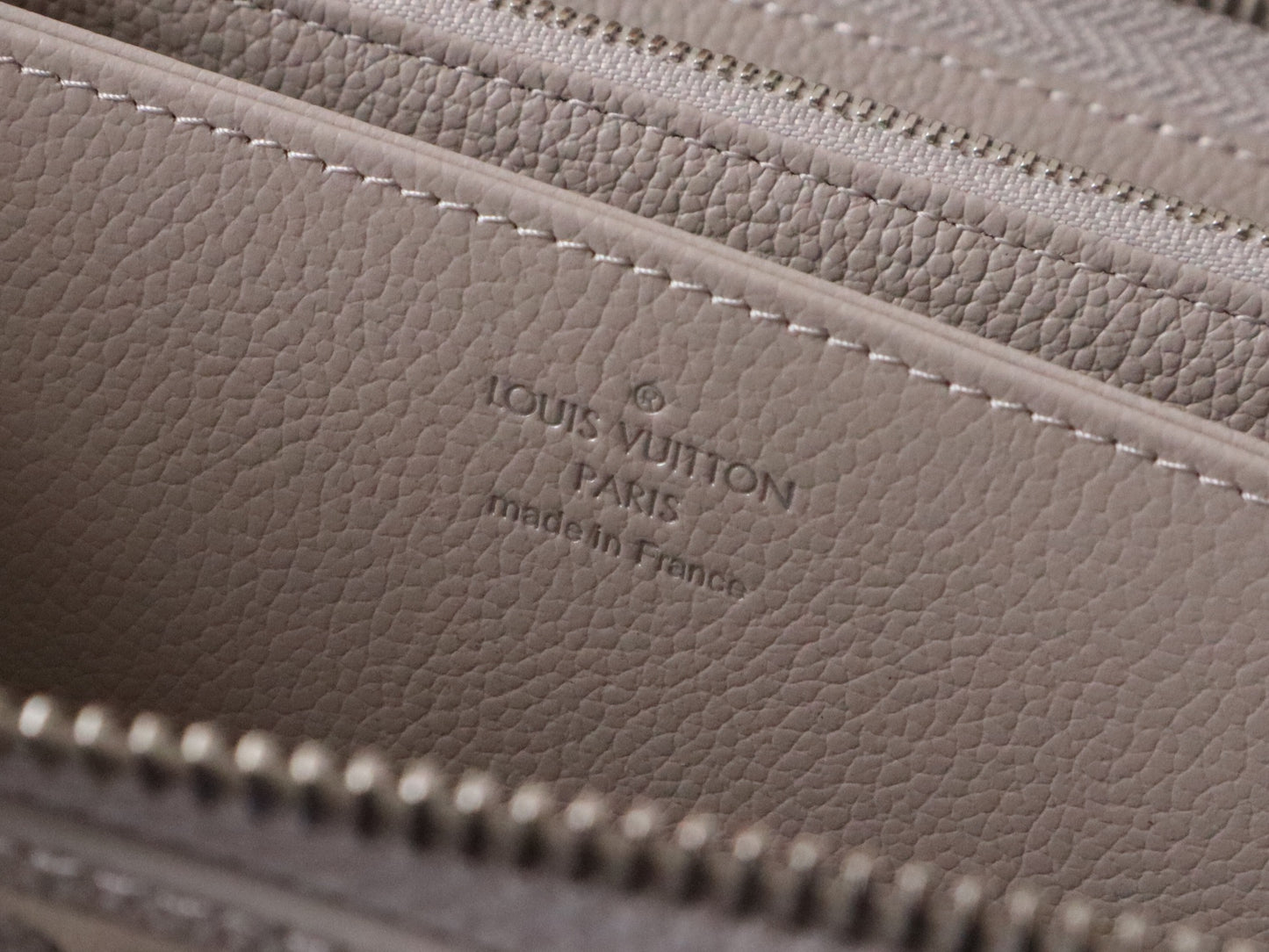 Elegant Louis Vuitton Light Gray Embossed Leather Zip Around Wallet for Luxury Enthusiasts M14228