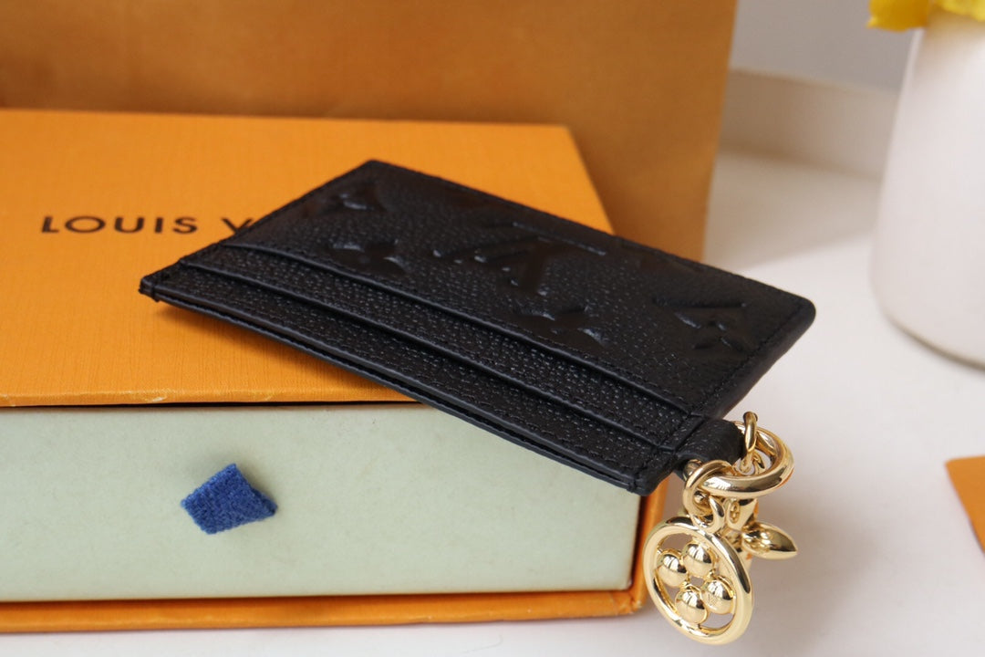 Chic Louis Vuitton Black Embossed Leather Card Holder With Gold Keychain Accent