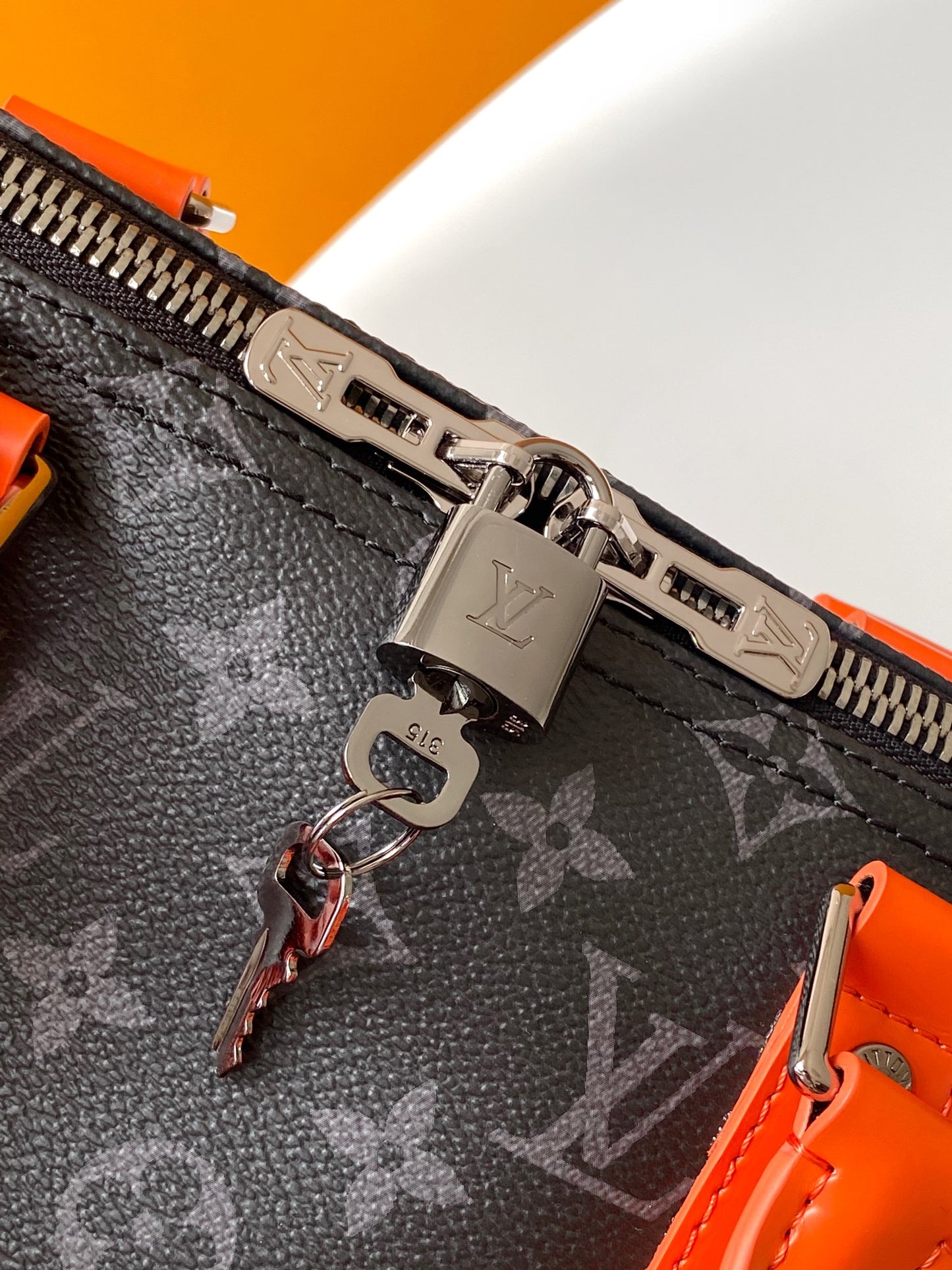 Louis Vuitton Monogram Canvas Travel Bag With Vibrant Orange Accents For Stylish Journeys