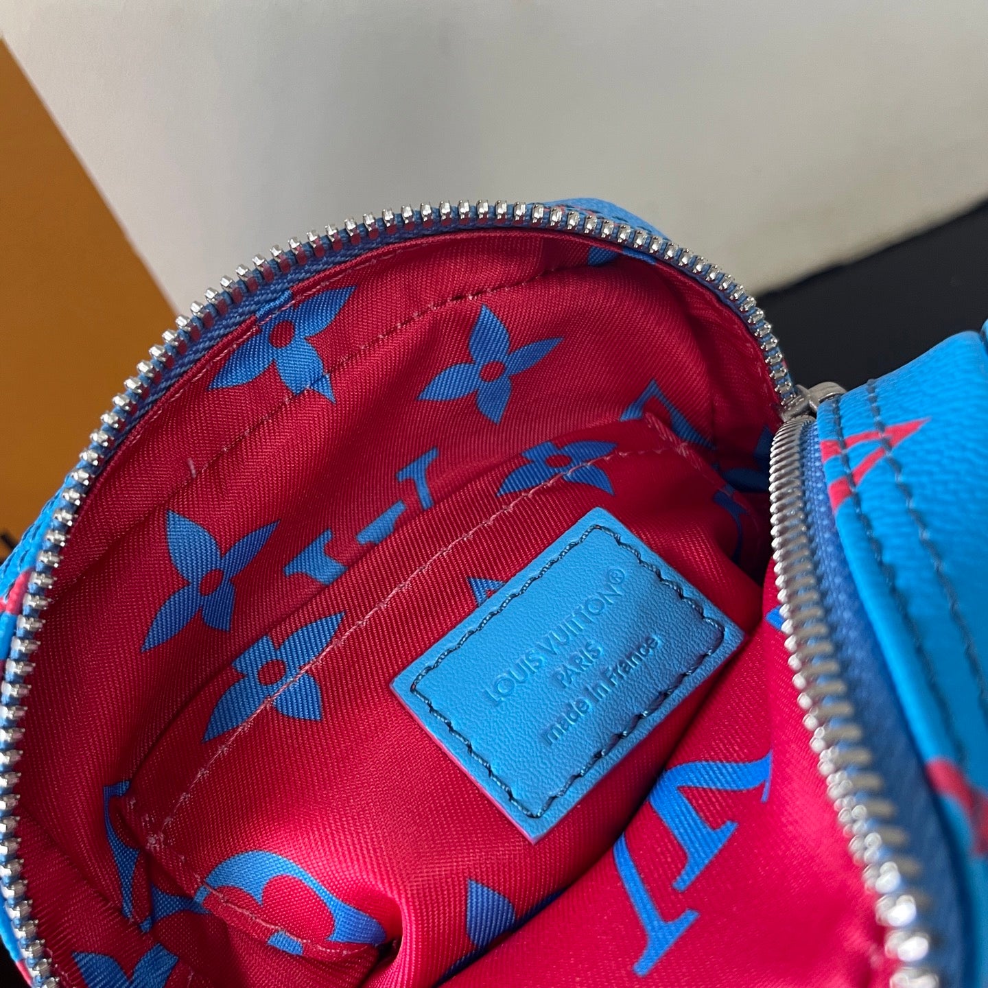 Eye Catching Blue Louis Vuitton Crossbody Bag With Red Monogram Pattern And Adjustable Strap