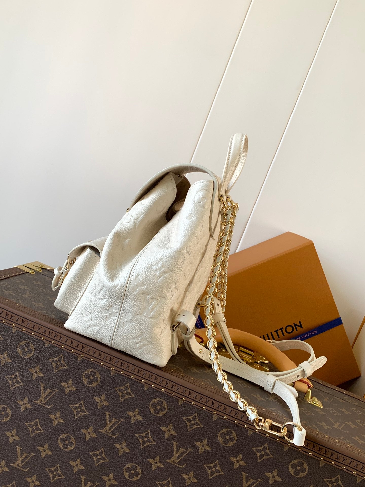 Elegant Louis Vuitton White/Black/Pink Embossed Leather Backpack With Functional Pockets And Gold Accents
