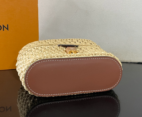 Chic Louis Vuitton Woven Straw Vanity Bag With Leather Handle And Lock Accents