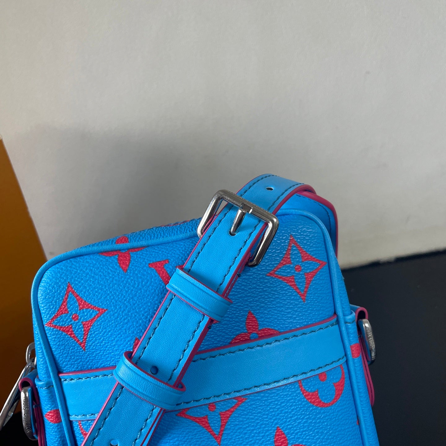 Eye Catching Blue Louis Vuitton Crossbody Bag With Red Monogram Pattern And Adjustable Strap