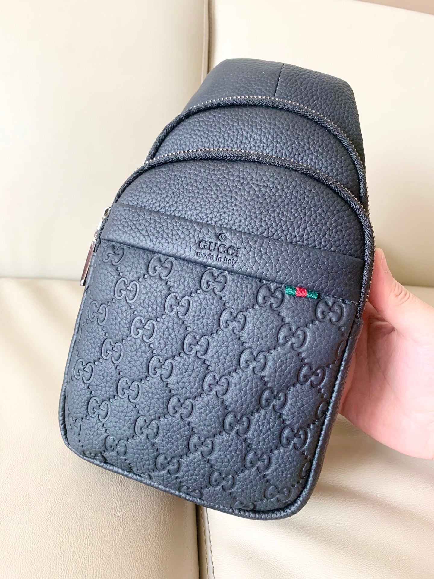 Stylish Black Gucci Sling Bag With Embossed GG Pattern And Brand Detailing For Modern Fashion 3218
