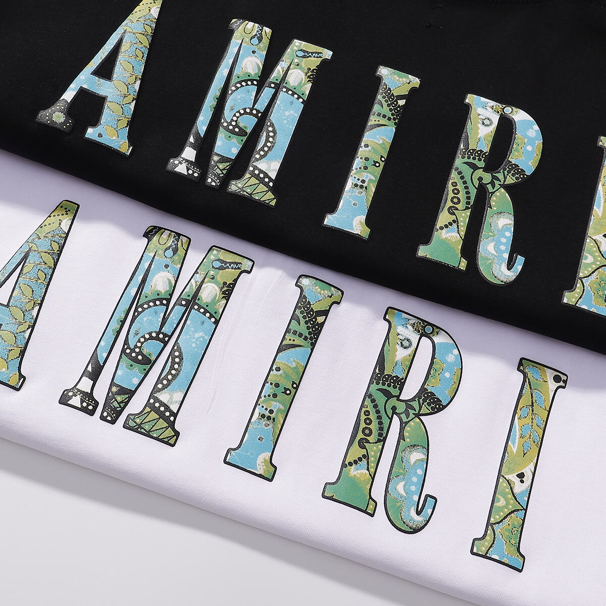 AMIRI White/Black Tee With Colorful Camo Logo For Stylish Streetwear Looks