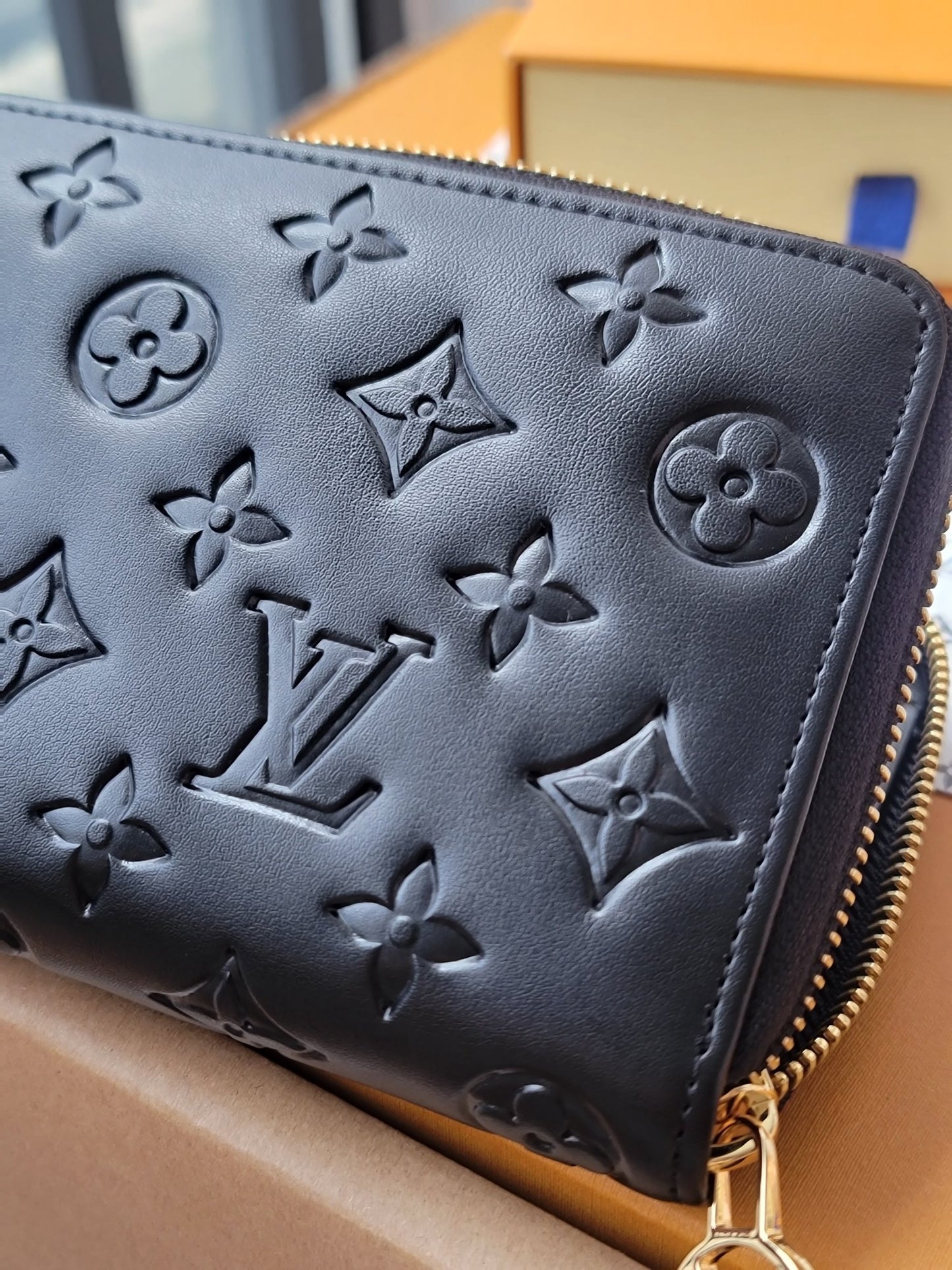 Elegant Louis Vuitton Black Embossed Leather Zip Around Wallet With Gold Accents