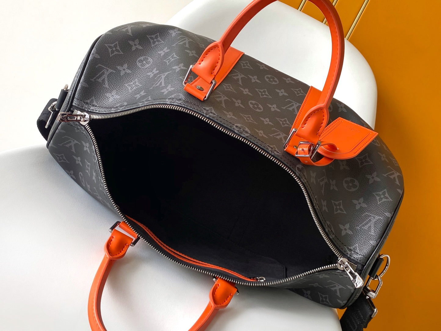 Louis Vuitton Monogram Canvas Travel Bag With Vibrant Orange Accents For Stylish Journeys