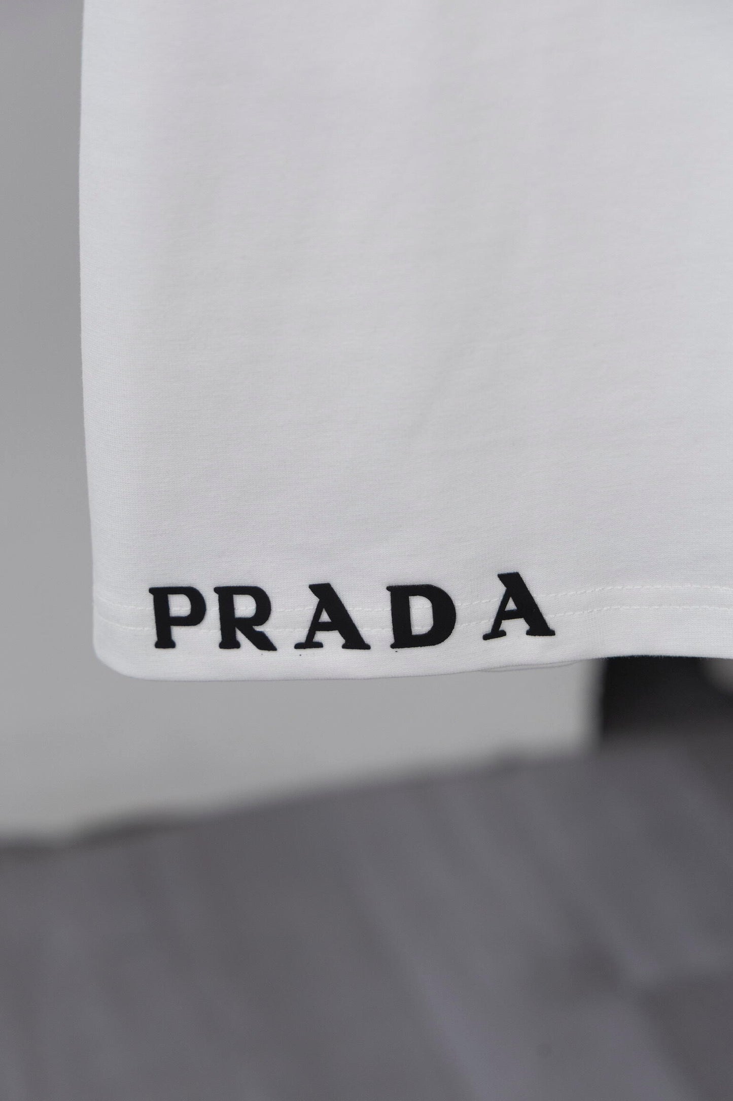 Prada Black/White Tee With Signature Logo Detailing For Luxury Fashion Lovers