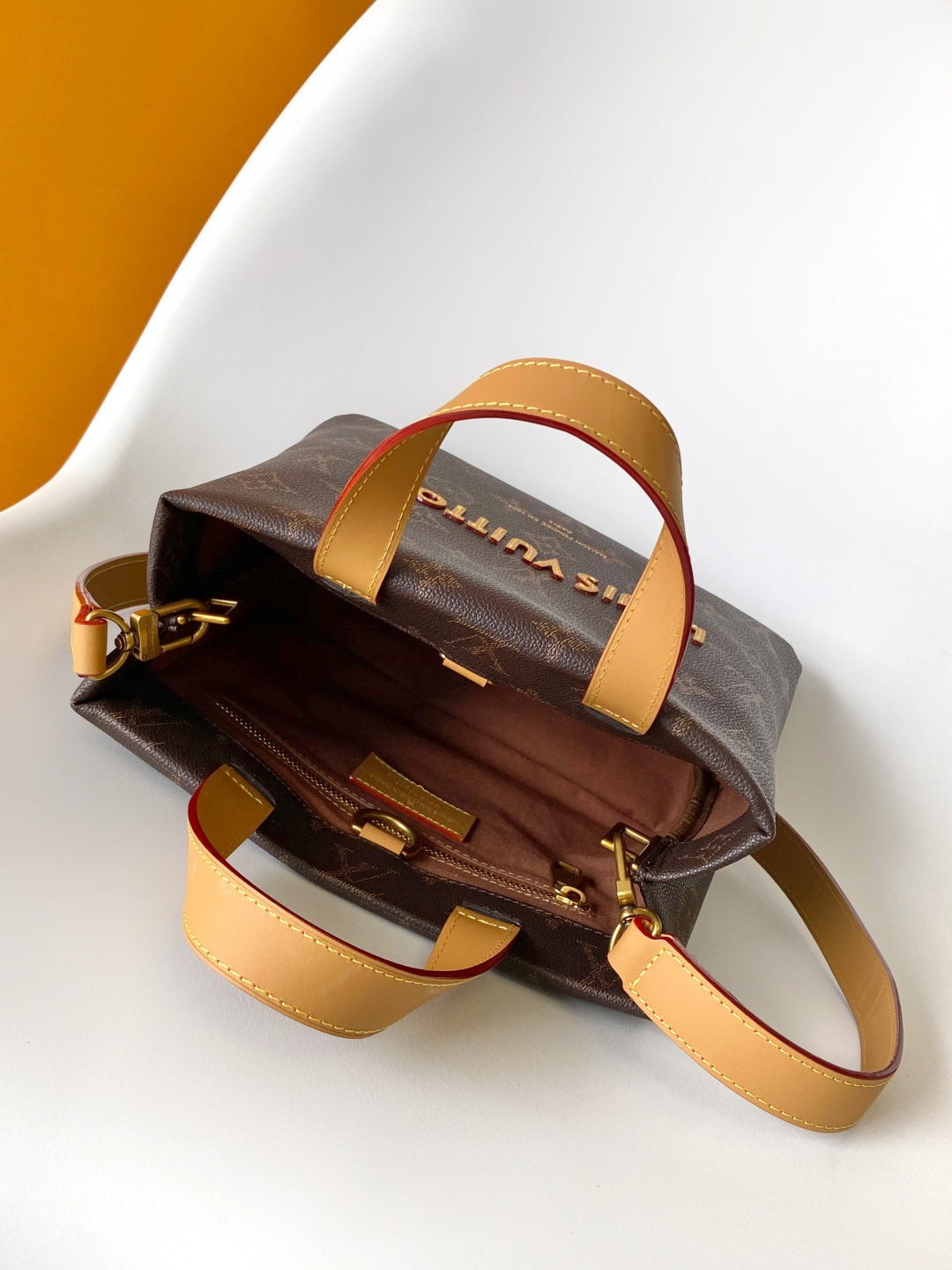 Elegant Louis Vuitton Monogram Canvas Tote Bag With Leather Handles And Gold Branding