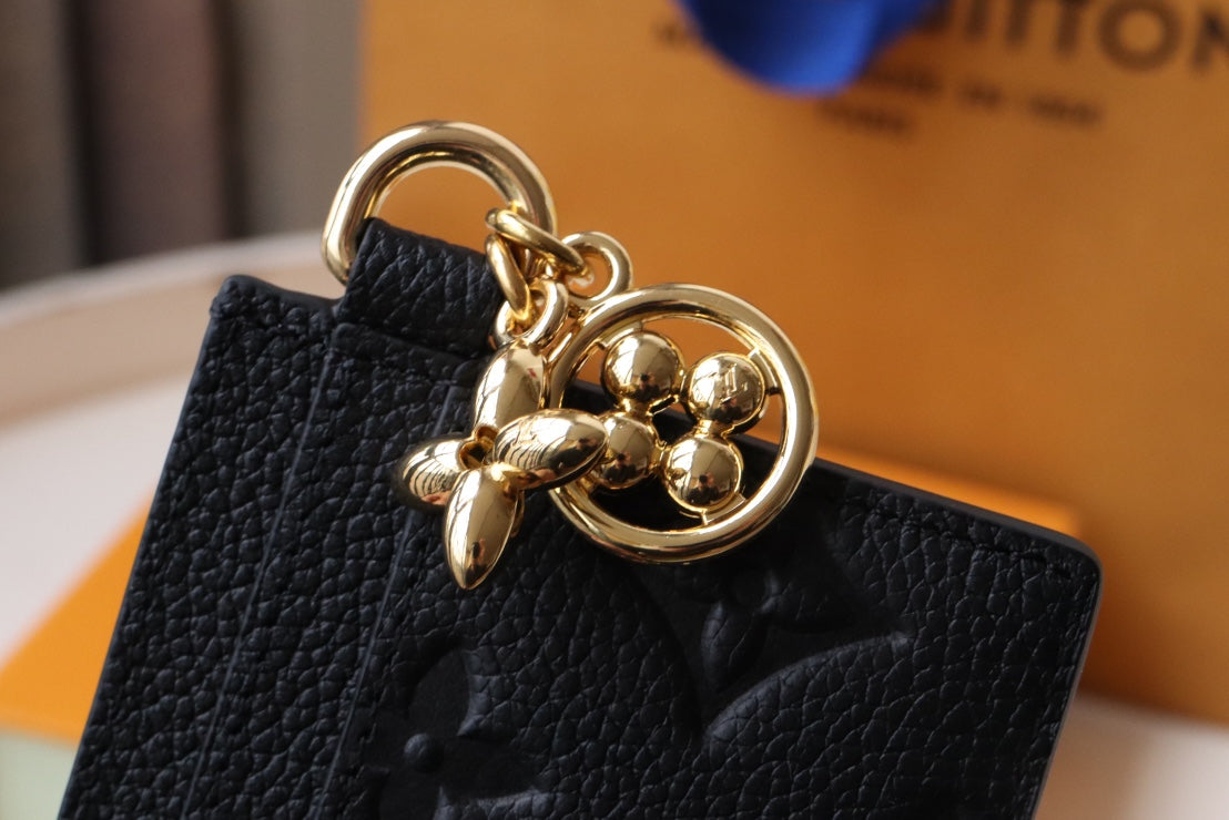 Chic Louis Vuitton Black Embossed Leather Card Holder With Gold Keychain Accent