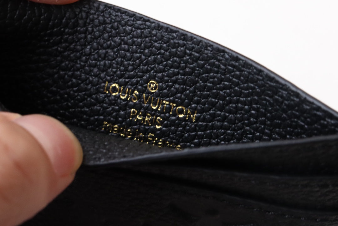 Chic Louis Vuitton Black Embossed Leather Card Holder With Gold Keychain Accent