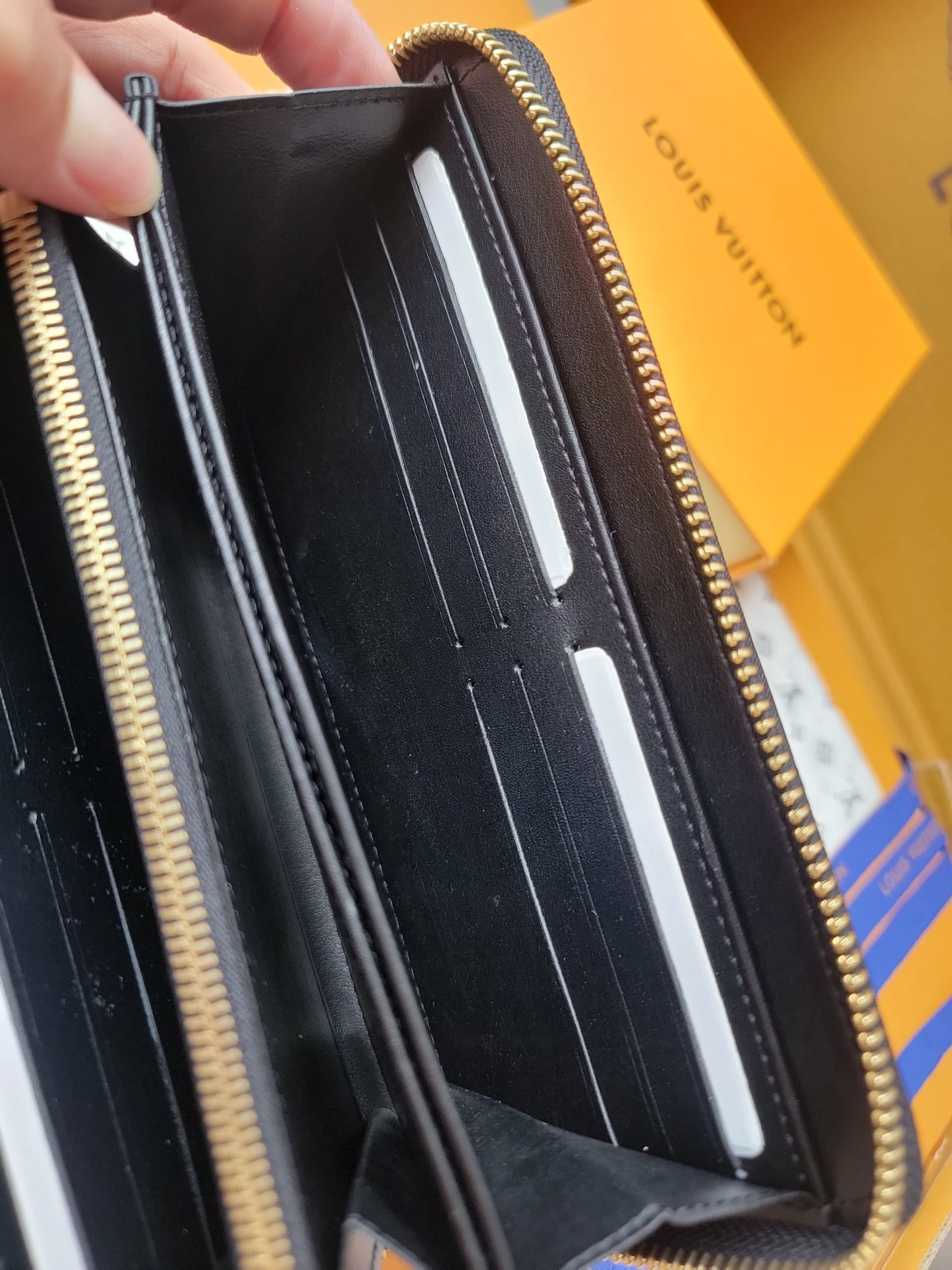 Elegant Louis Vuitton Black Embossed Leather Zip Around Wallet With Gold Accents