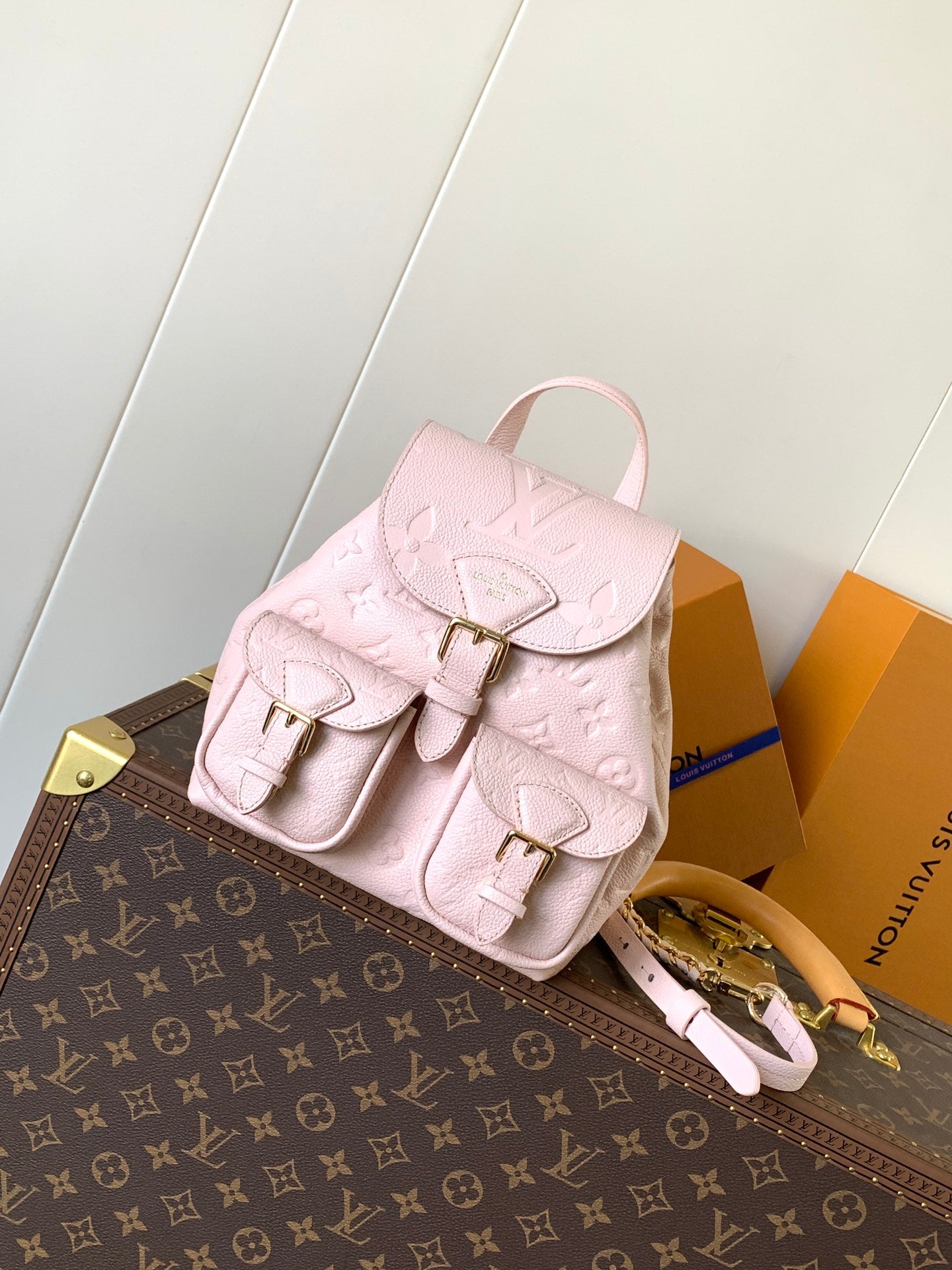 Elegant Louis Vuitton White/Black/Pink Embossed Leather Backpack With Functional Pockets And Gold Accents