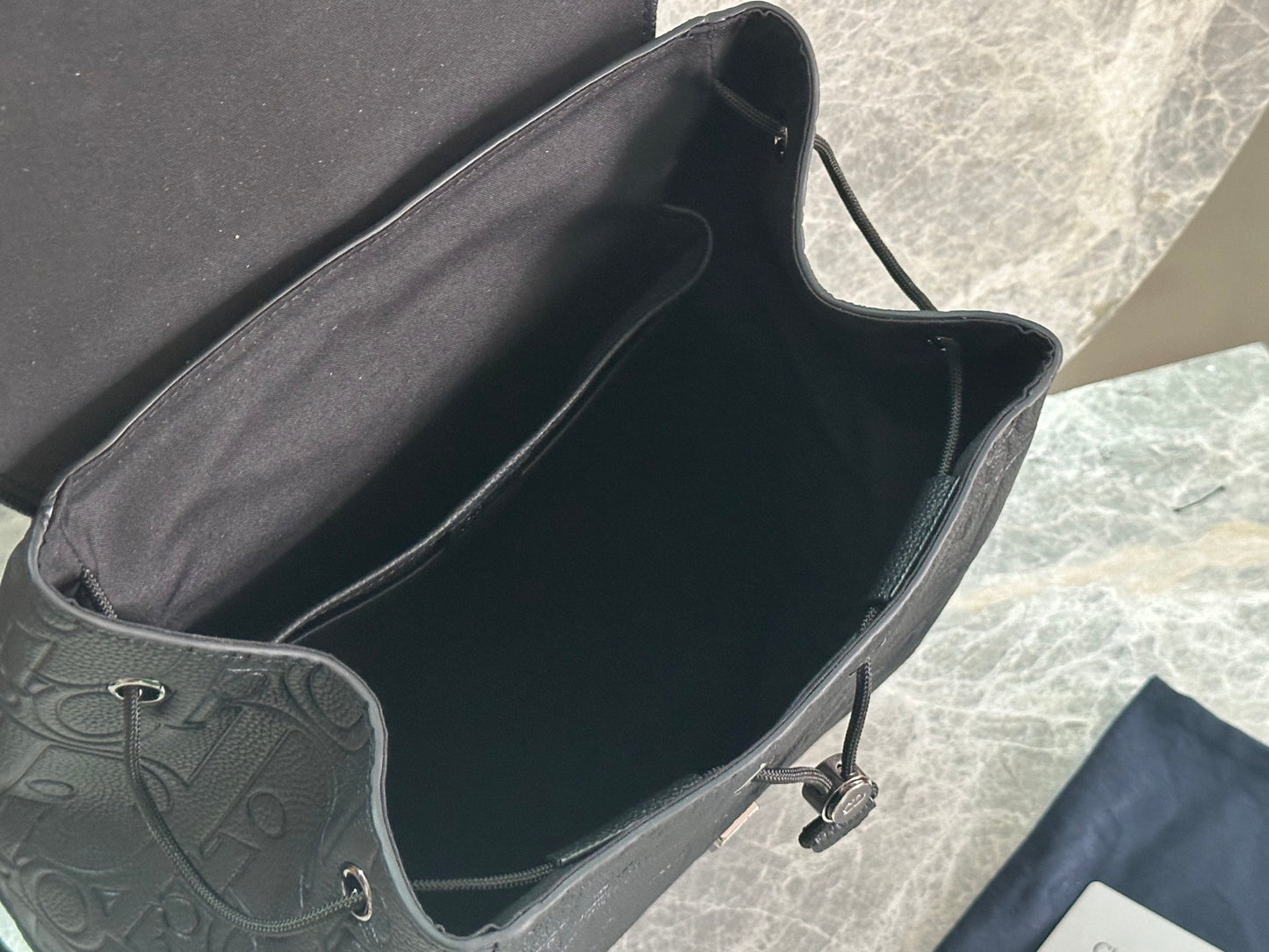 Elegant Dior Daily Black Leather Backpack With Embossed Monogram And Buckle Closure BA231