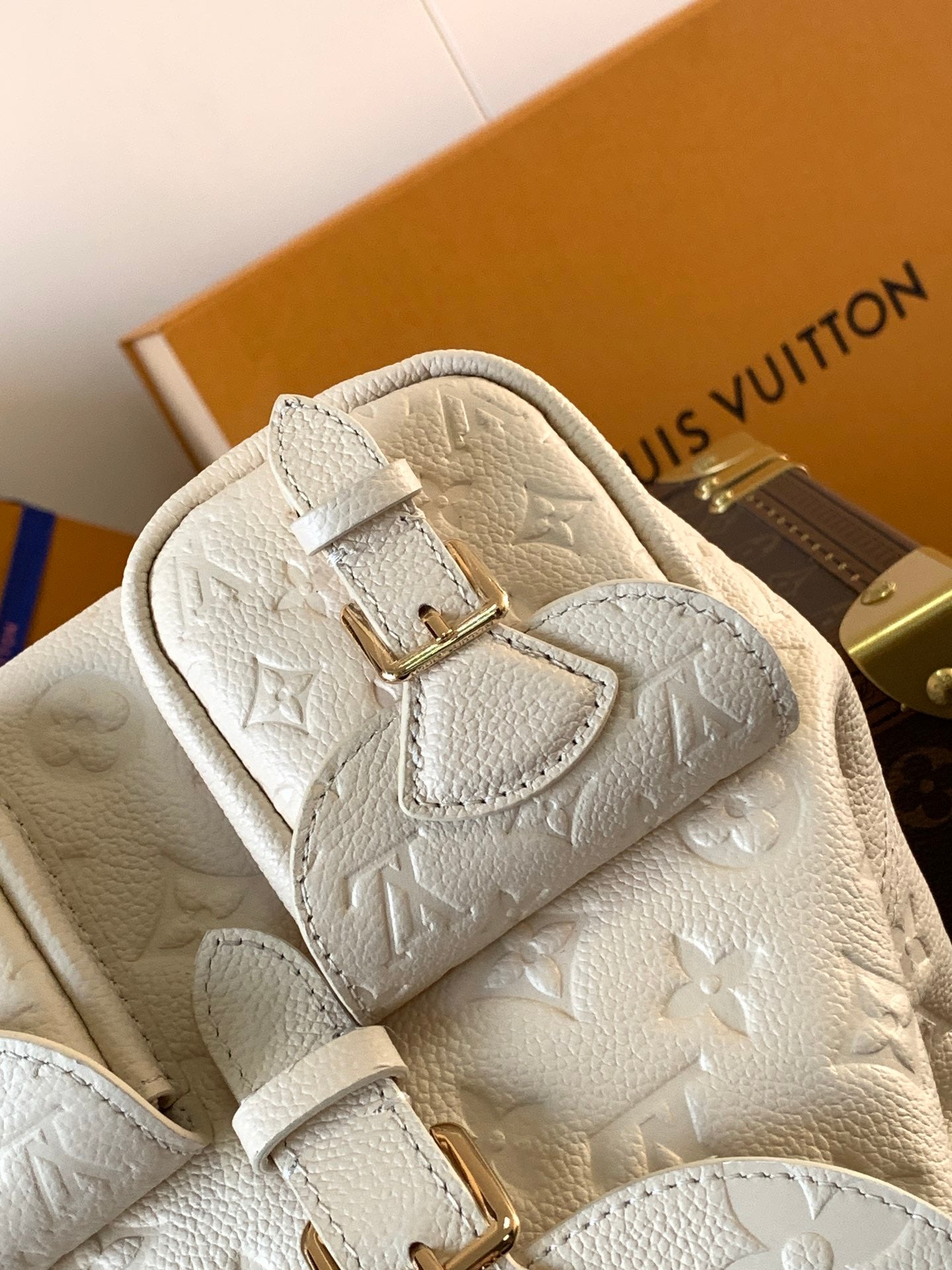 Elegant Louis Vuitton White/Black/Pink Embossed Leather Backpack With Functional Pockets And Gold Accents