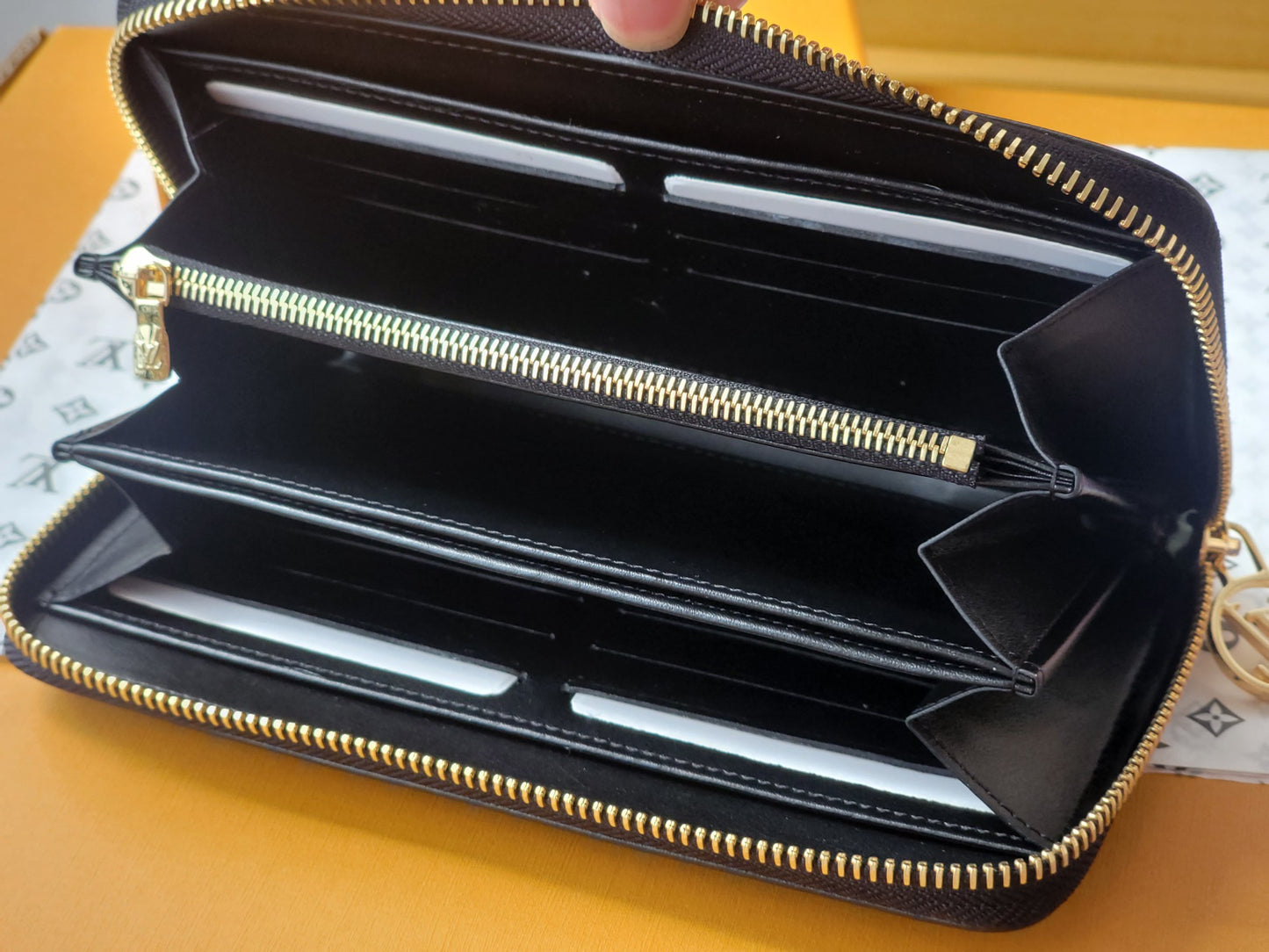 Elegant Louis Vuitton Black Embossed Leather Zip Around Wallet With Gold Accents