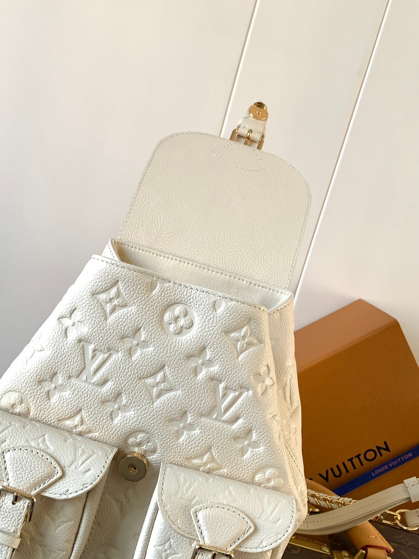 Elegant Louis Vuitton White/Black/Pink Embossed Leather Backpack With Functional Pockets And Gold Accents