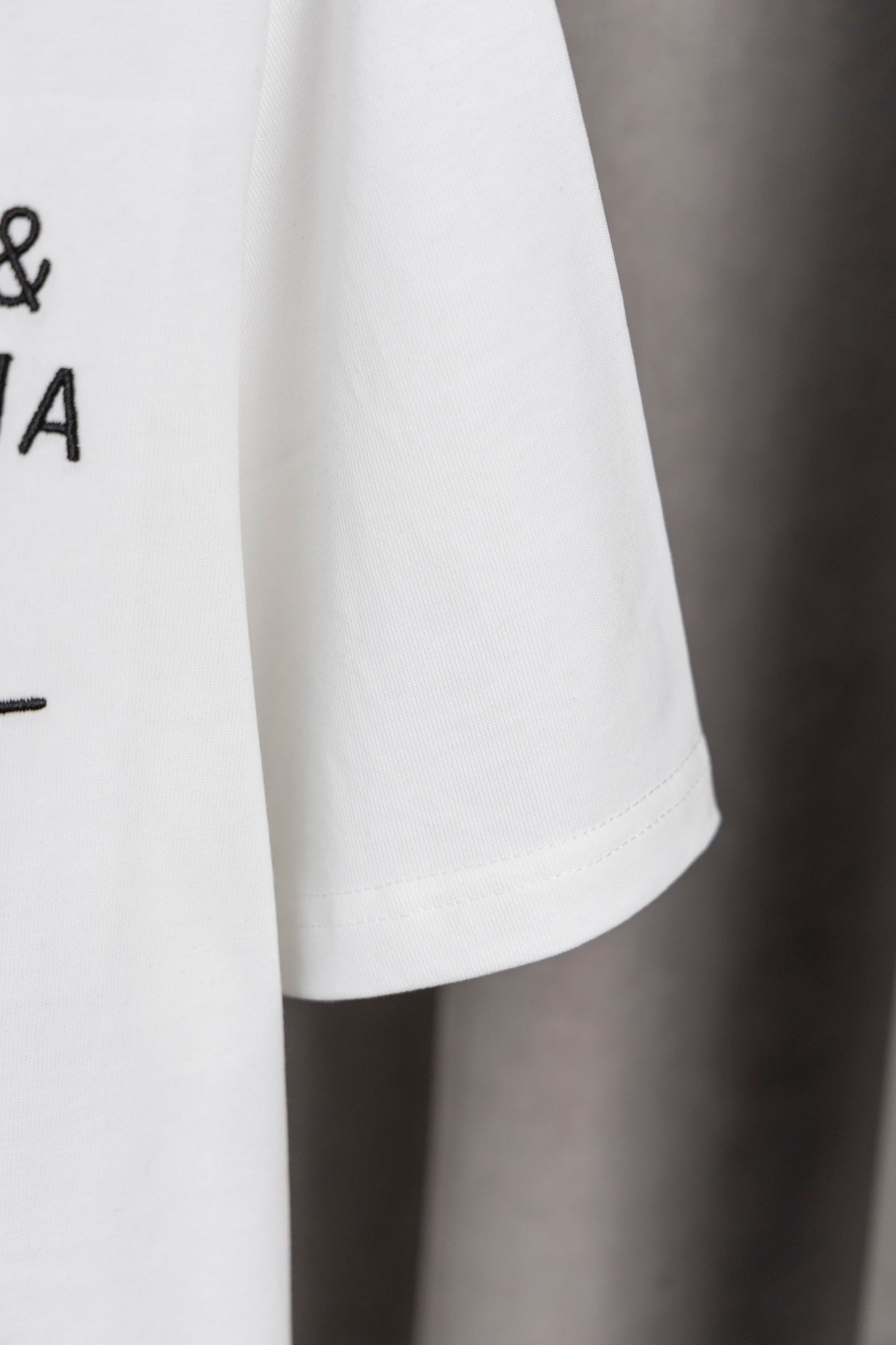 Elegant Dolce & Gabbana White/Black T - Shirt With Signature Branding For Fashion Enthusiasts