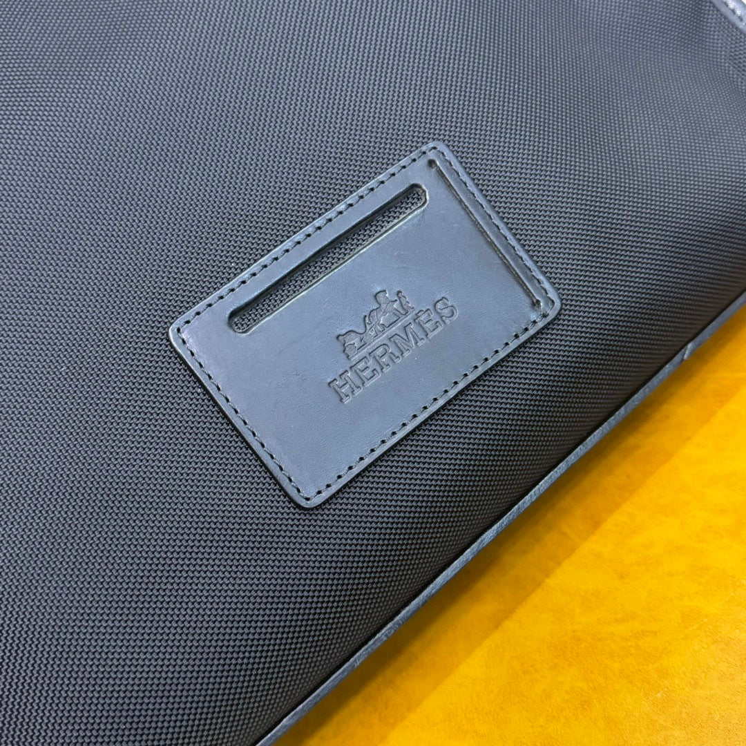 Hermès Black Canvas Briefcase With Leather Trim And Buckle Closure