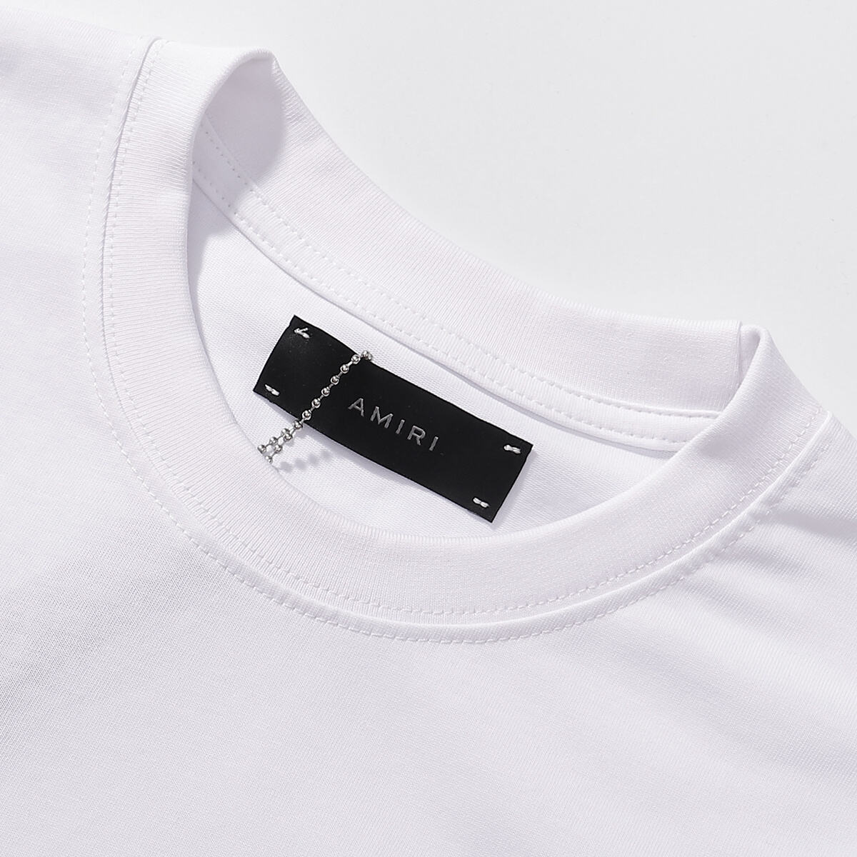 AMIRI Black/White Tee With “I AM what I AM” Slogan For Bold Streetwear Statements