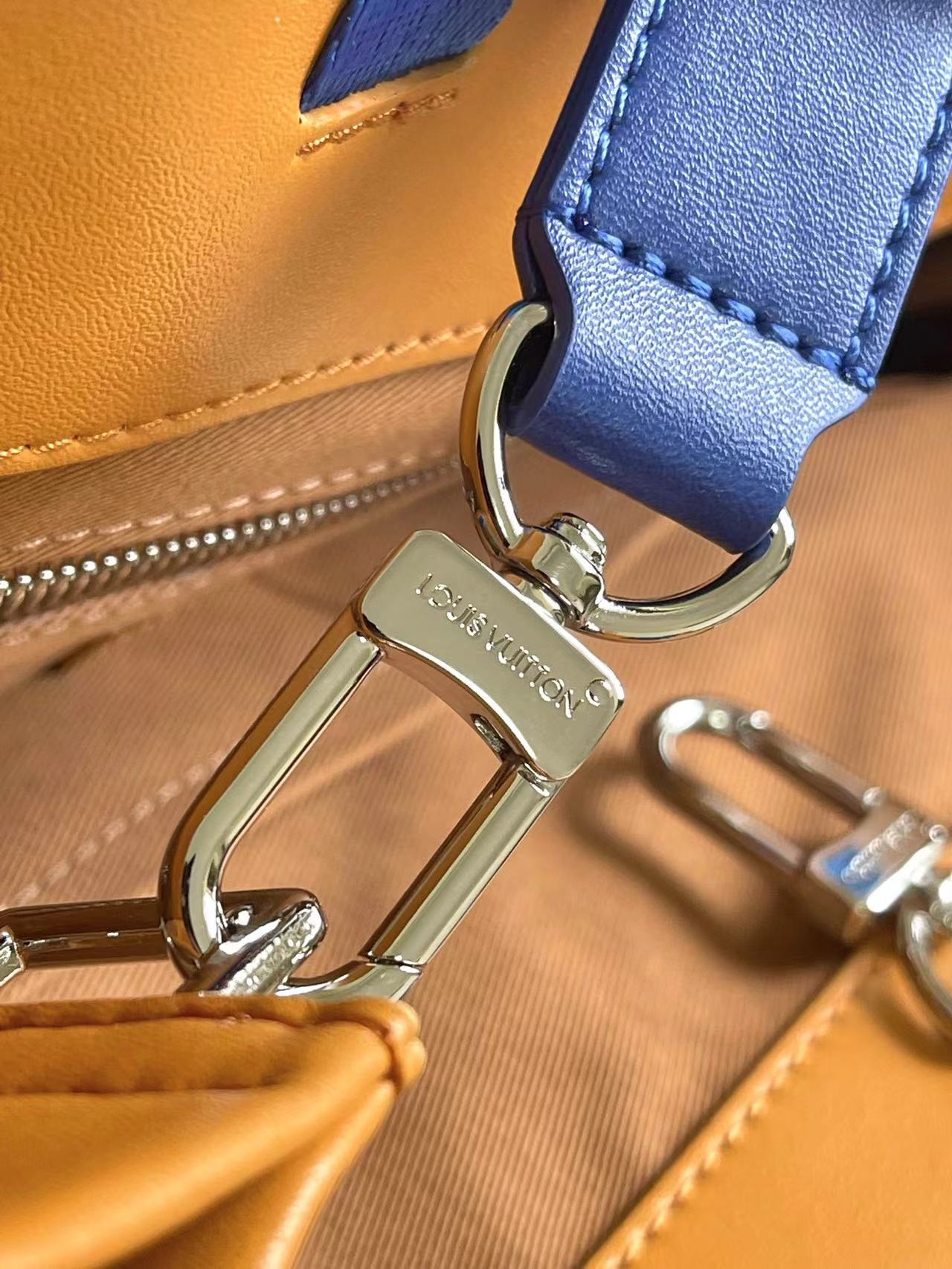 Stylish Orange Louis Vuitton Tote Bag With Blue Handles And Branding