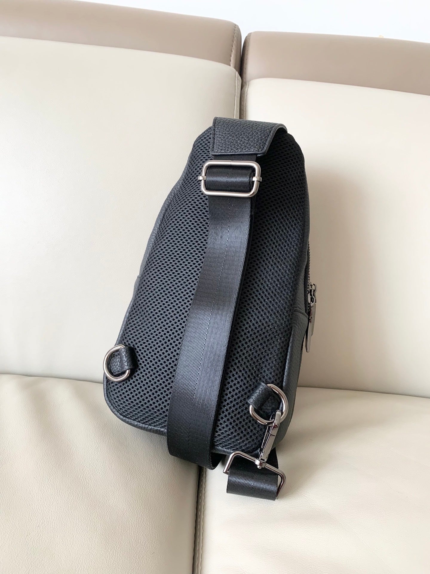 Stylish Black Gucci Sling Bag With Embossed GG Pattern And Brand Detailing For Modern Fashion 3218