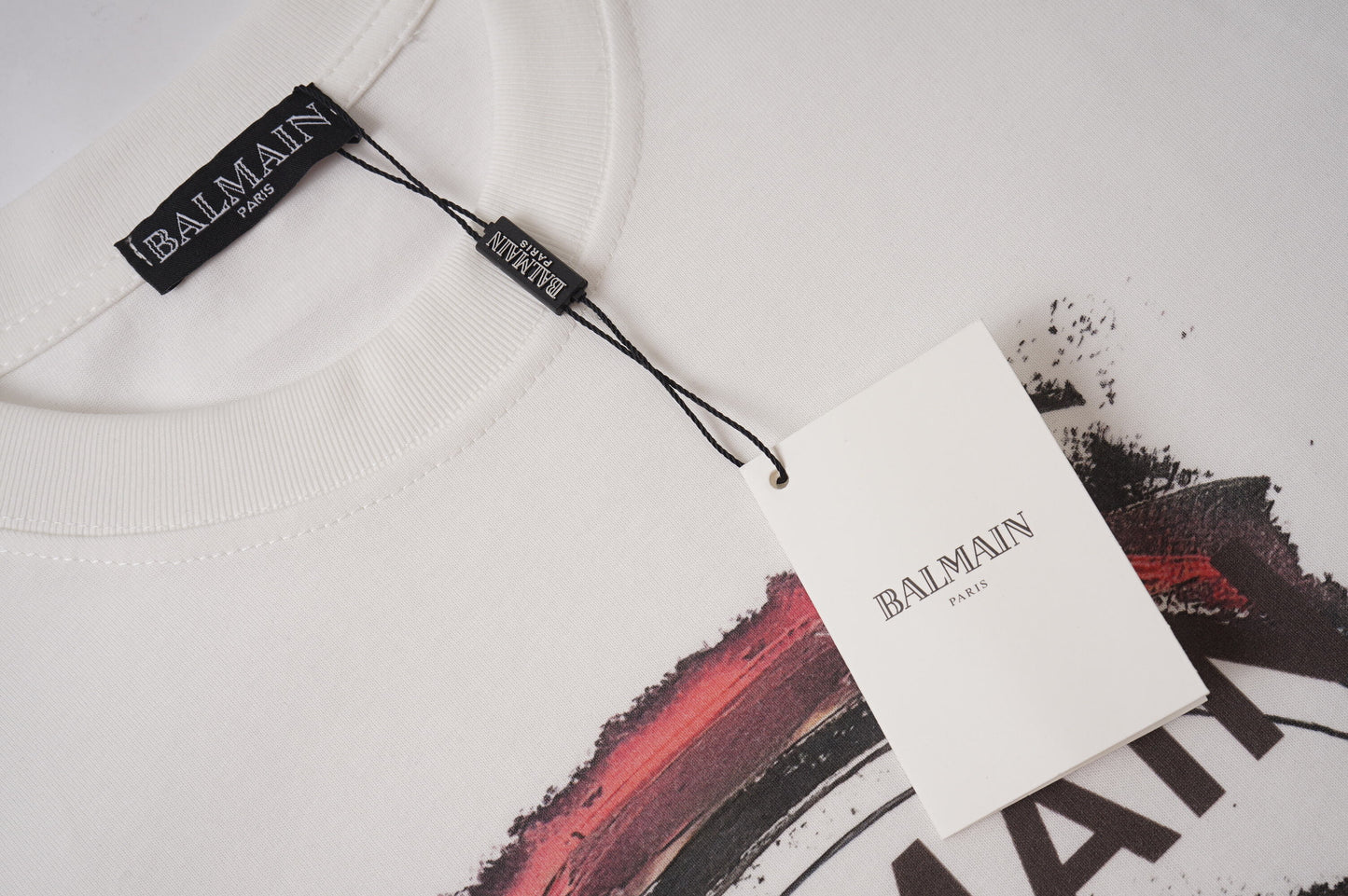 Balmain White/Black Tee With Cosmic Astronaut Graphic For Edgy High - Fashion Looks