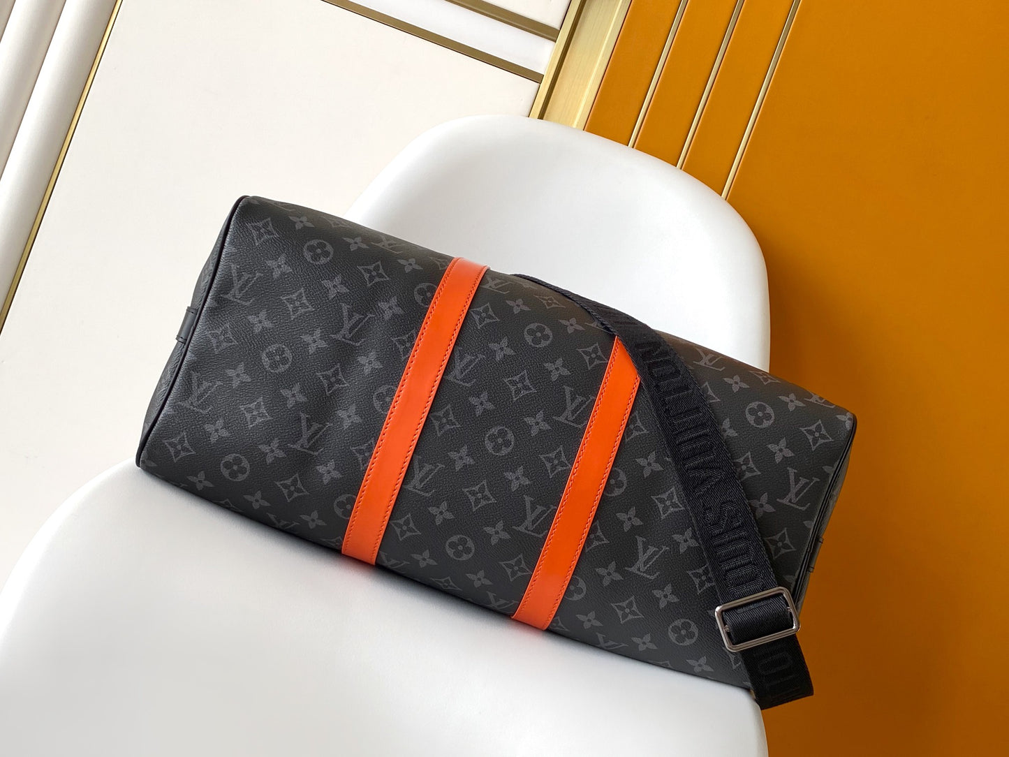 Louis Vuitton Monogram Canvas Travel Bag With Vibrant Orange Accents For Stylish Journeys
