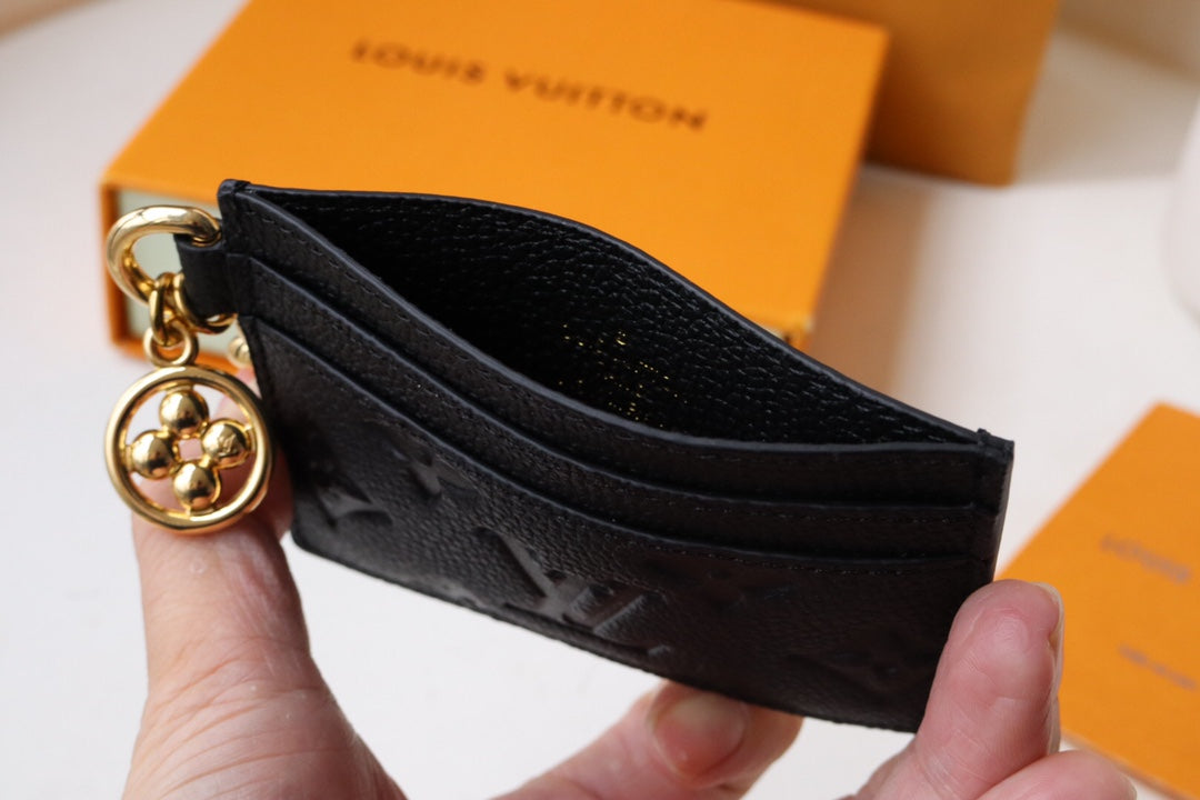 Chic Louis Vuitton Black Embossed Leather Card Holder With Gold Keychain Accent