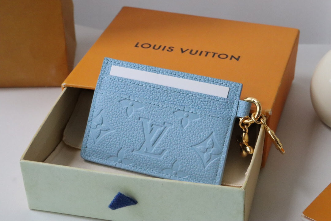 Chic Louis Vuitton Black Embossed Leather Card Holder With Gold Keychain Accent