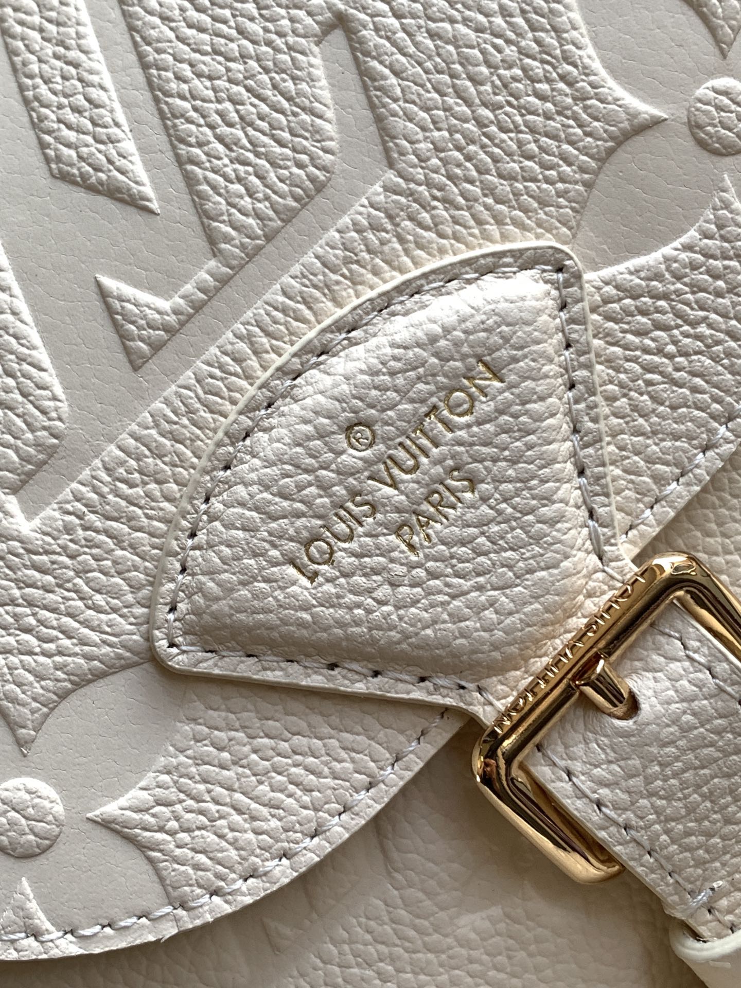 Elegant Louis Vuitton White/Black/Pink Embossed Leather Backpack With Functional Pockets And Gold Accents