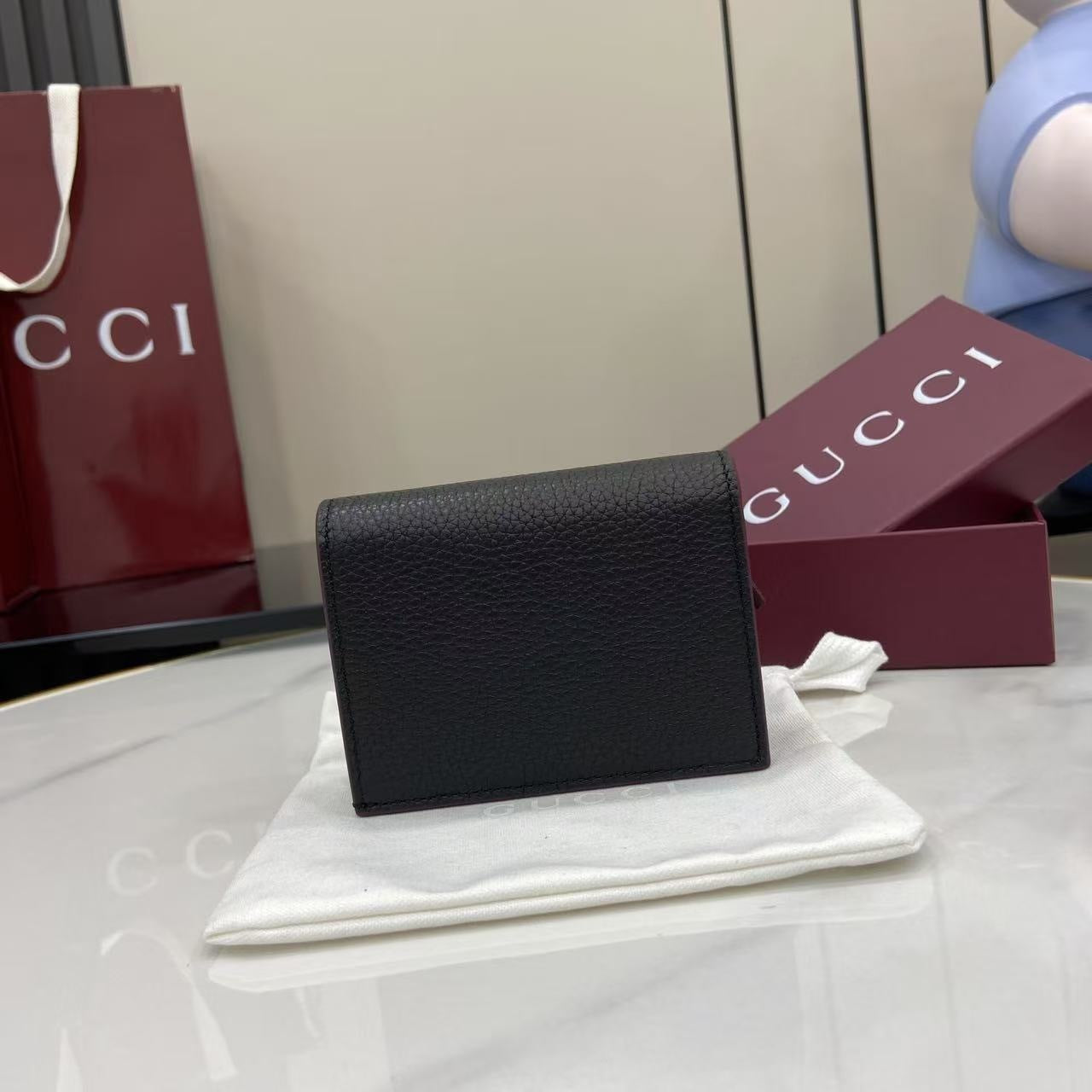 Elegant Black Gucci Wallet With Iconic Gold GG Logo For Timeless Luxury Accessory 456126