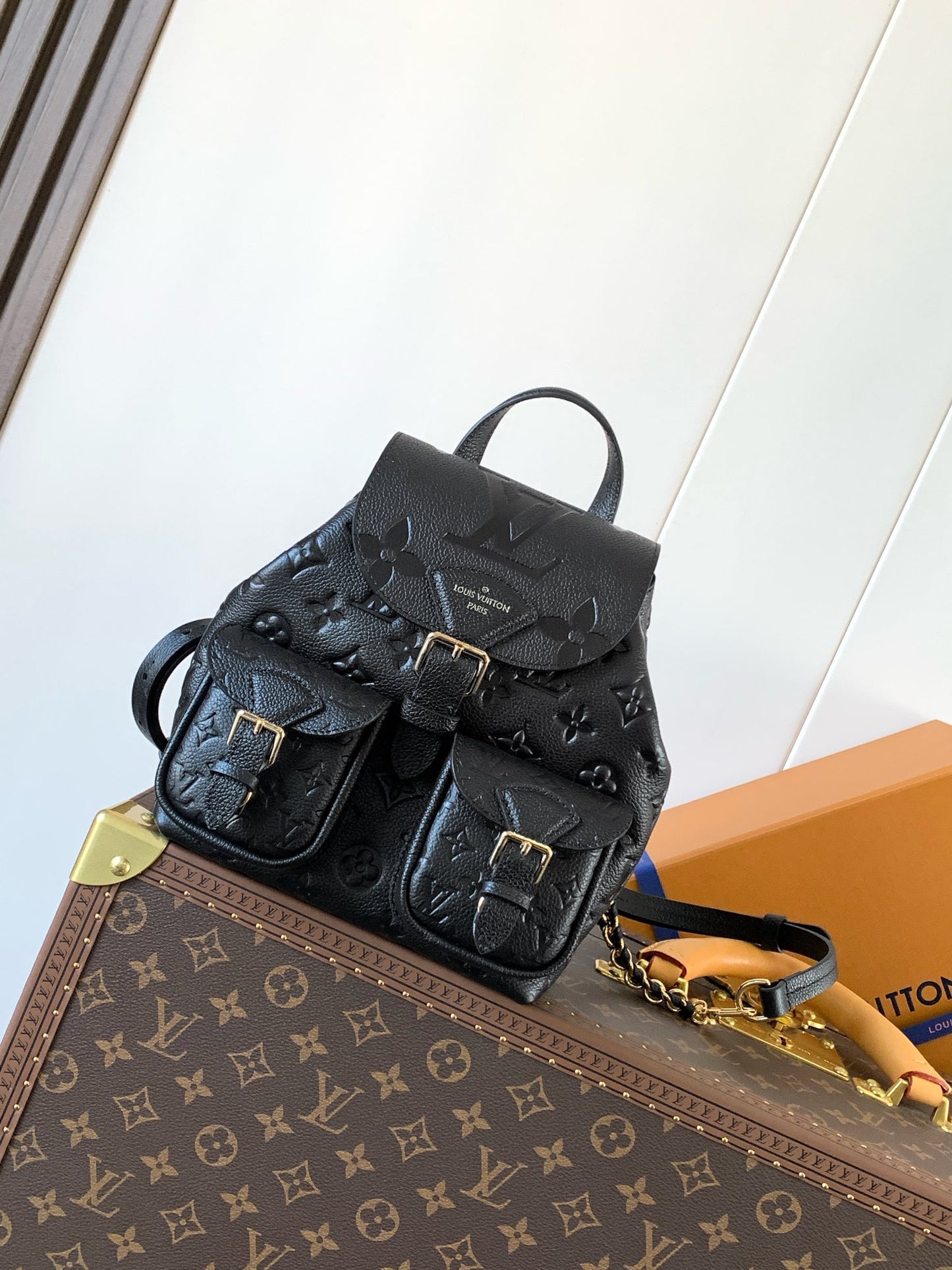 Elegant Louis Vuitton White/Black/Pink Embossed Leather Backpack With Functional Pockets And Gold Accents