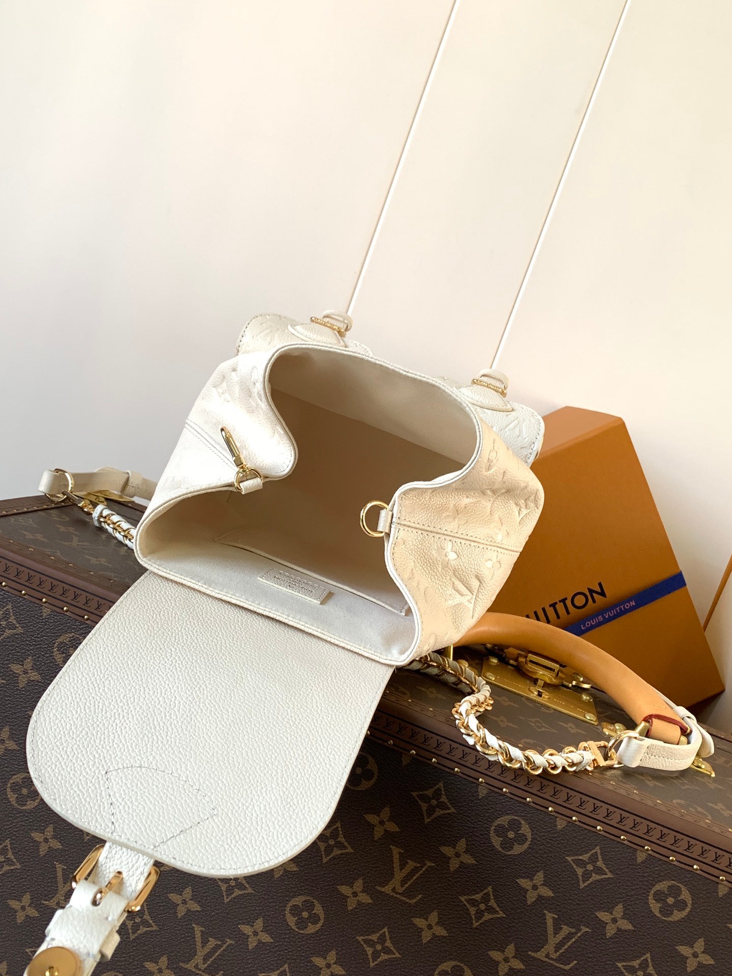 Elegant Louis Vuitton White/Black/Pink Embossed Leather Backpack With Functional Pockets And Gold Accents