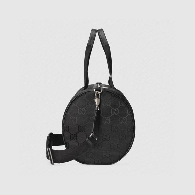 Elegant Black Gucci Duffle Bag With Signature GG Pattern And Gold Branding 658632