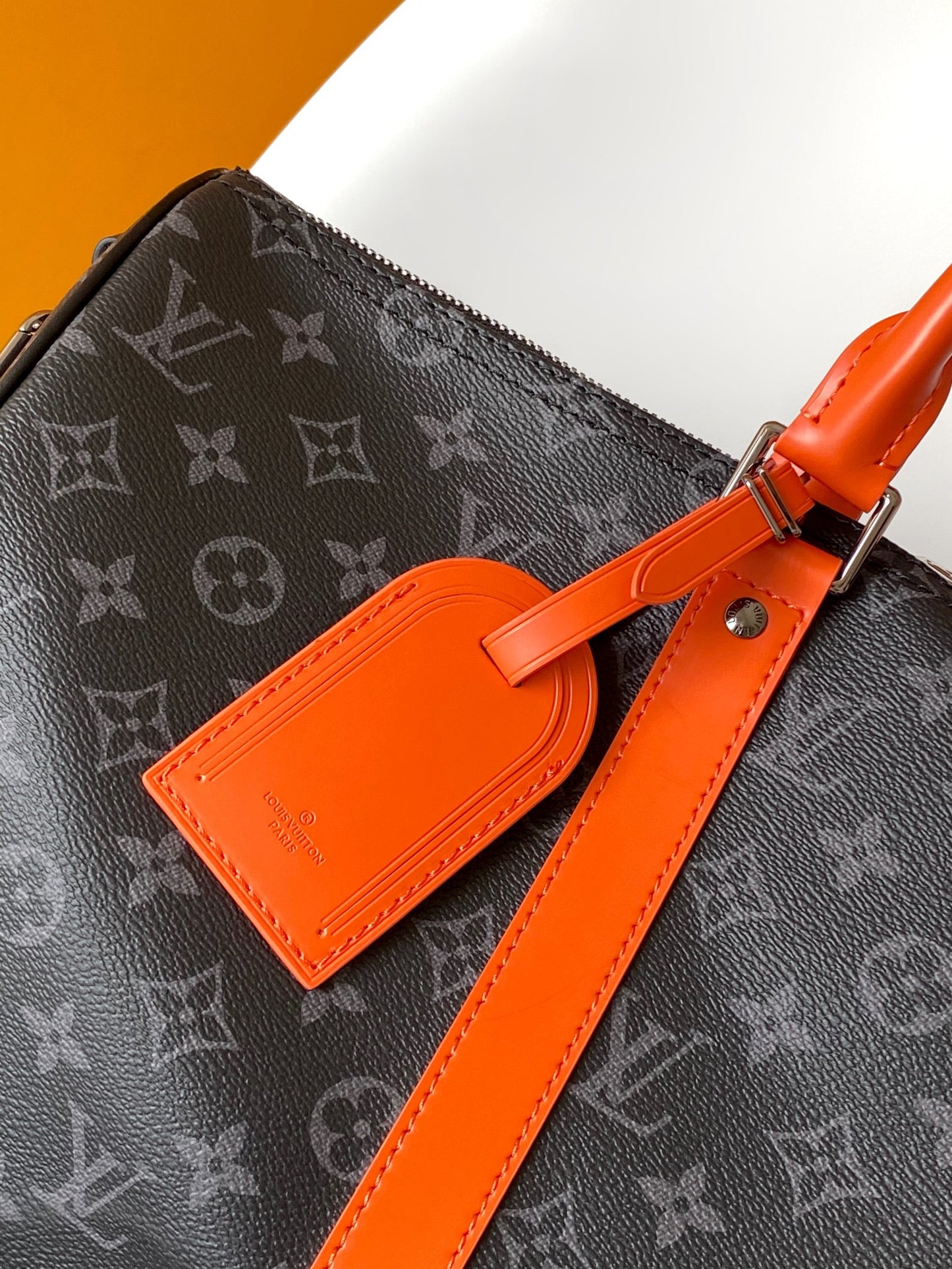 Louis Vuitton Monogram Canvas Travel Bag With Vibrant Orange Accents For Stylish Journeys