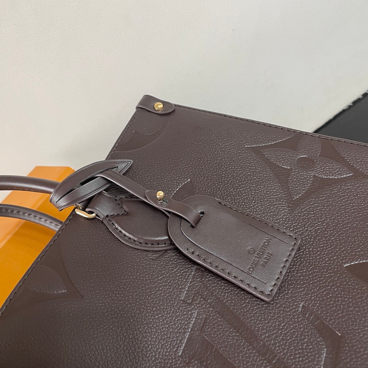 Elegant Louis Vuitton Gray Embossed Leather Tote Bag With Signature Monogram Patterns