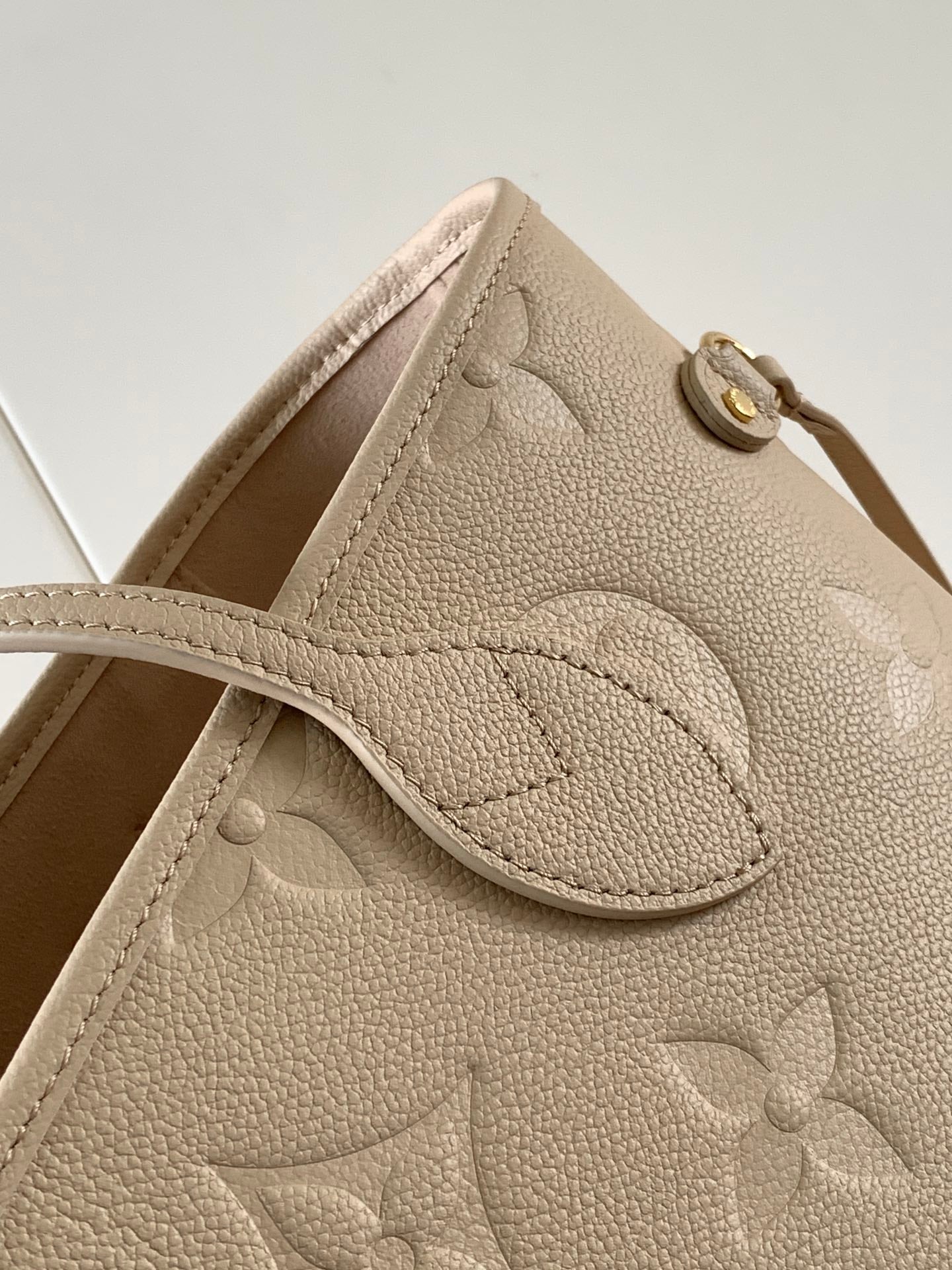 Elegant Louis Vuitton Cream Empreinte Leather Neverfull Tote Bag for Fashion Enthusiasts