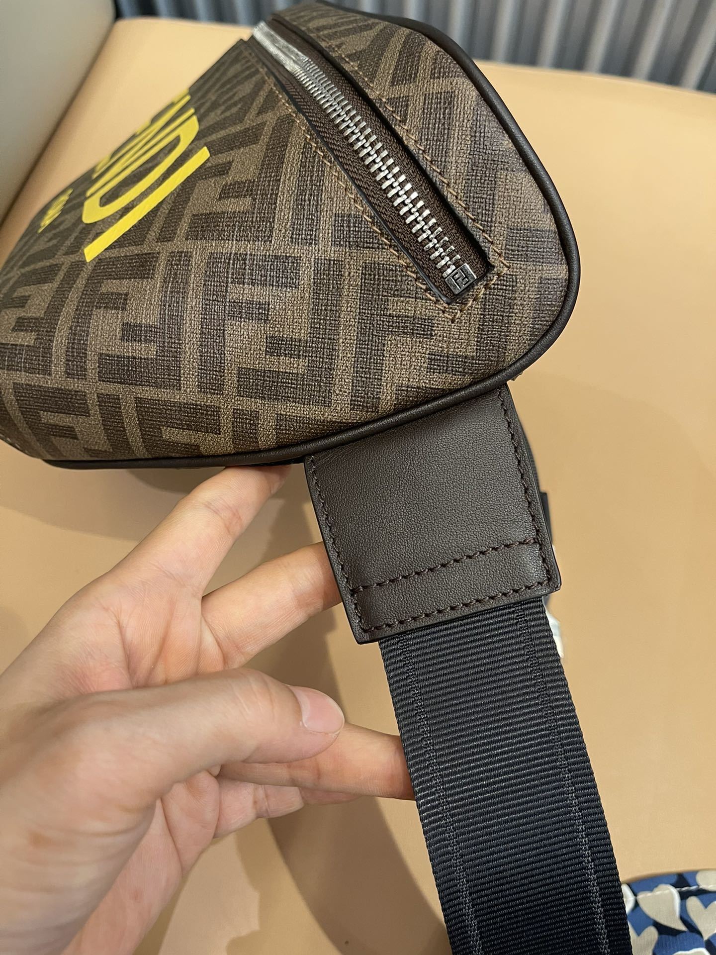 Stylish Fendi Belt Bag With Iconic FF Pattern And Bold Yellow Branding 7vA562