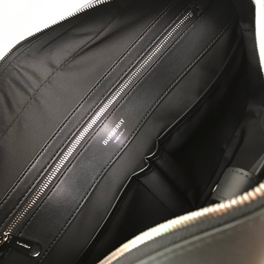 Sleek Black Burberry Briefcase With Woven Texture For Sophisticated Business And Travel Looks