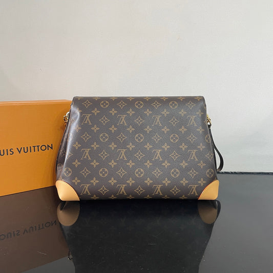 Classic Louis Vuitton Monogram Canvas Handbag With Lock Detail And Stylish Design