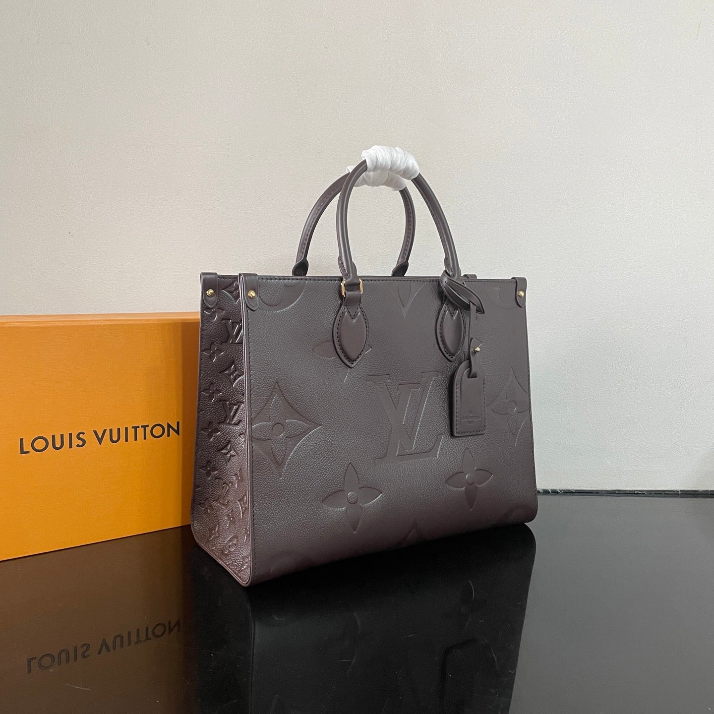 Elegant Louis Vuitton Gray Embossed Leather Tote Bag With Signature Monogram Patterns
