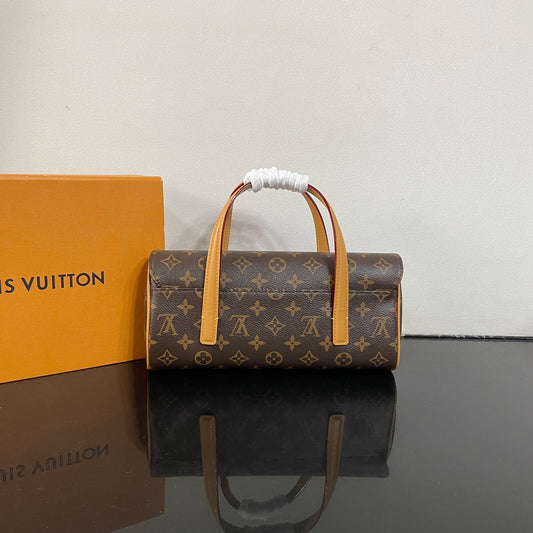 Classic Louis Vuitton Monogram Cylinder Handbag With Leather Handles And Timeless Design