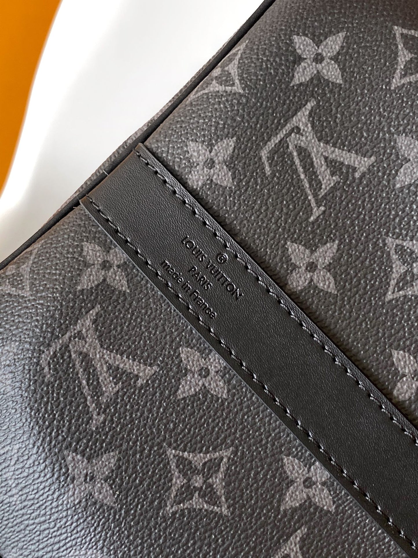 Louis Vuitton Monogram Canvas Travel Bag With Vibrant Orange Accents For Stylish Journeys